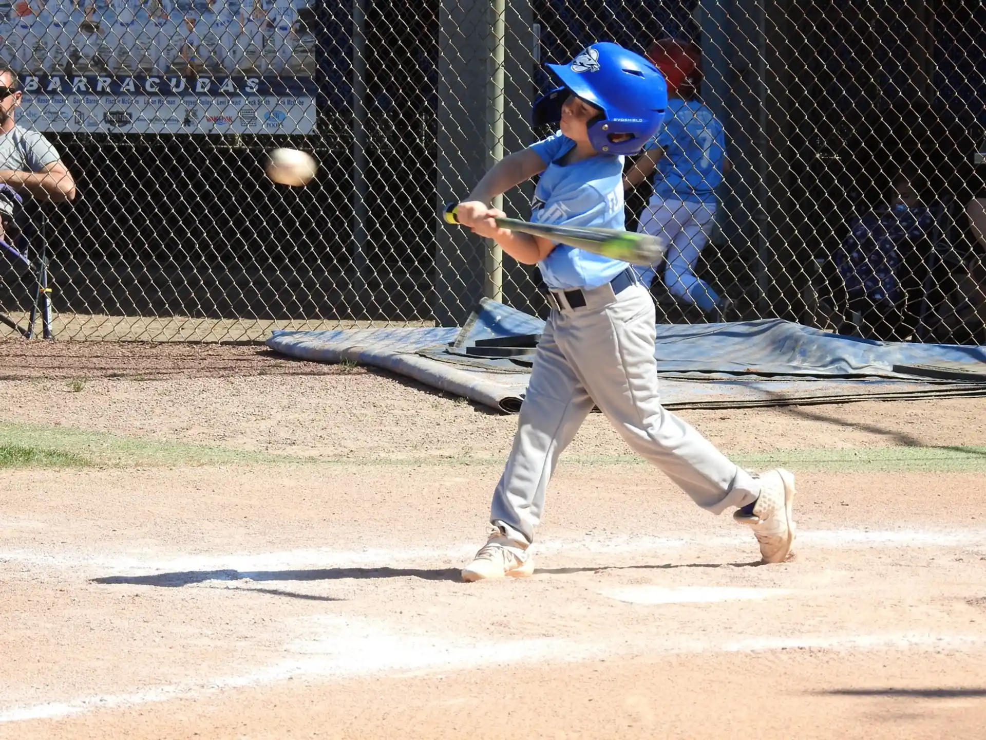 a young boy swinging a baseball bat