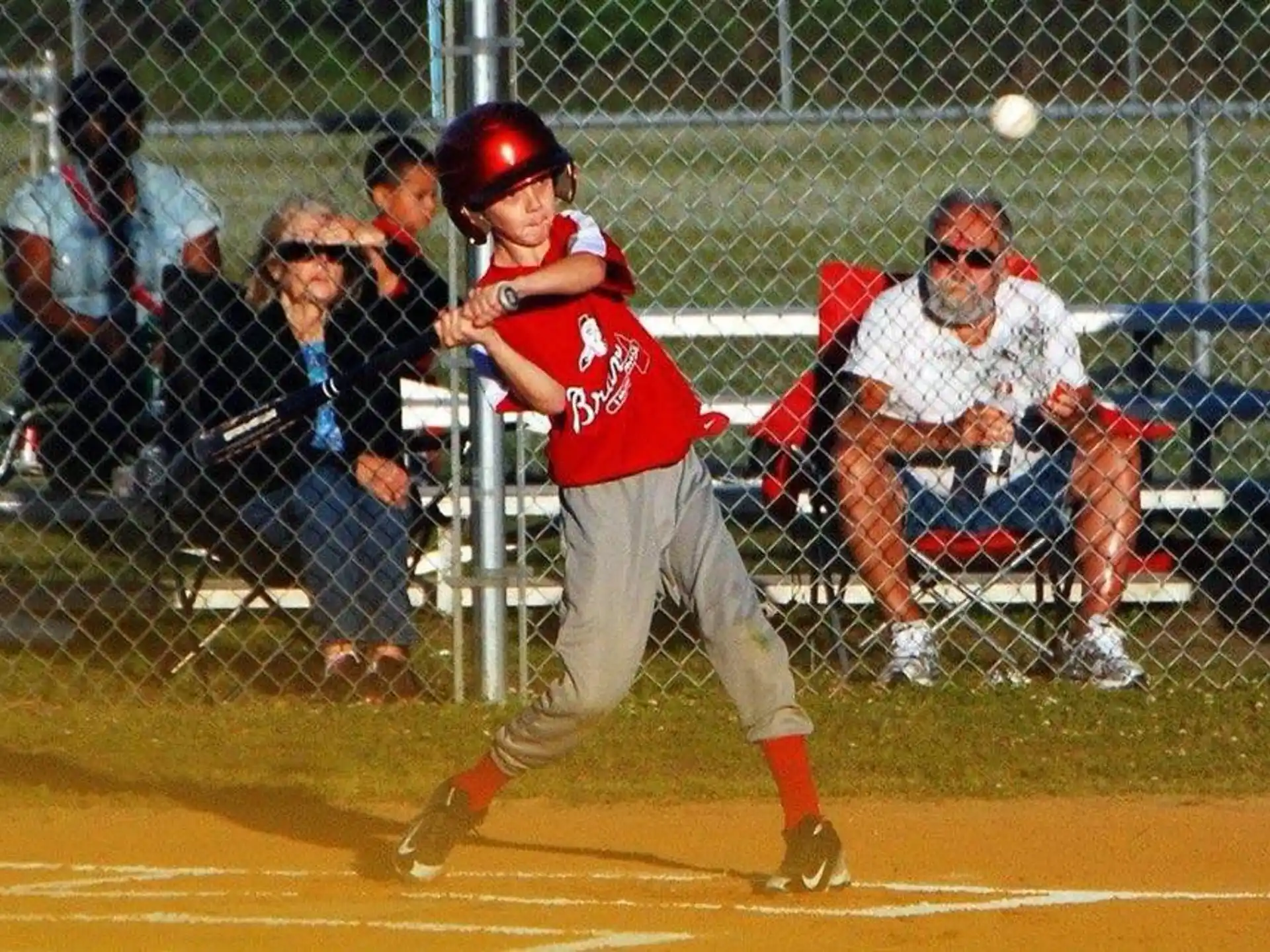 a baseball player hitting a ball with his bat