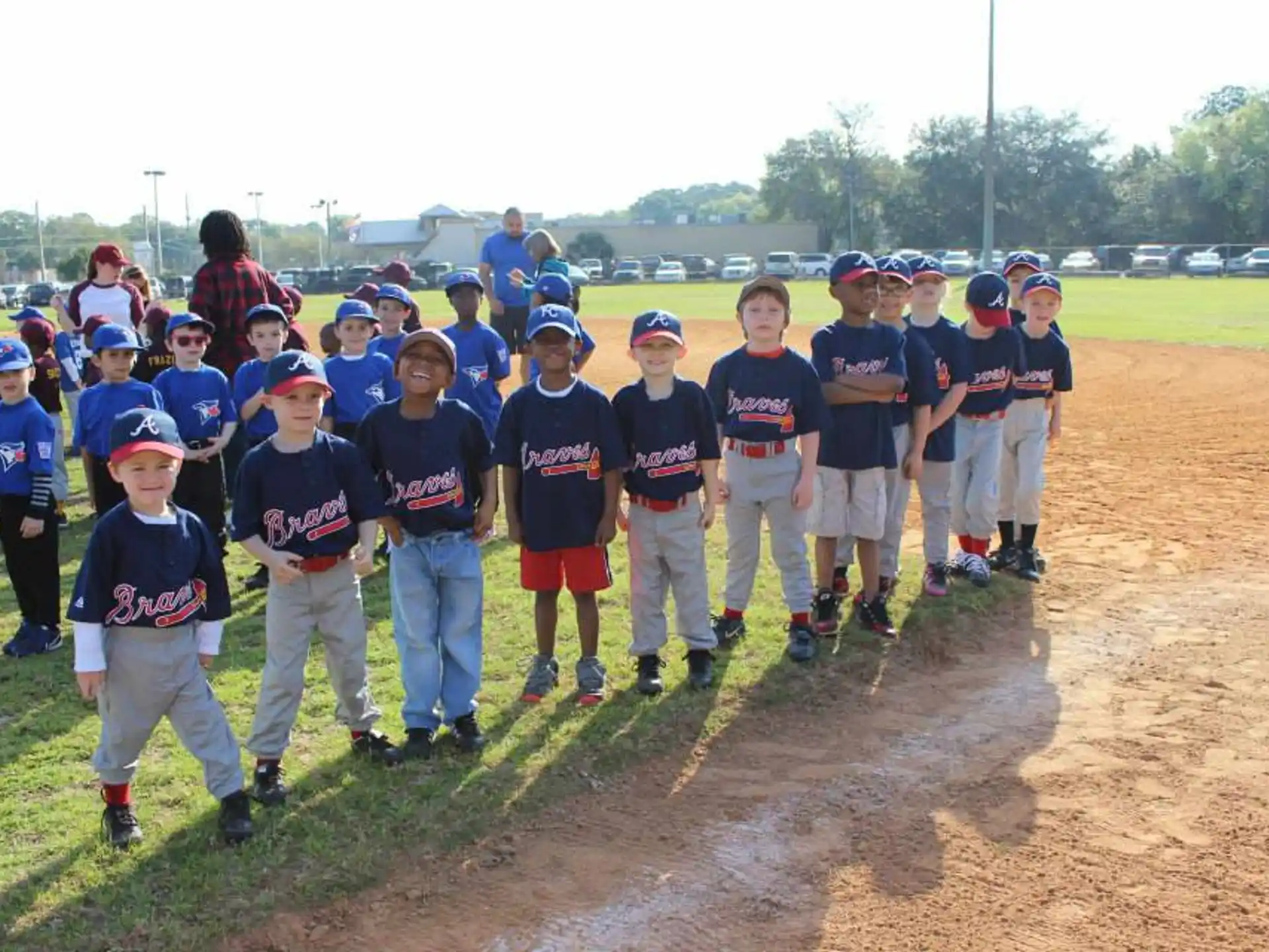 a group of kids in baseball uniforms
