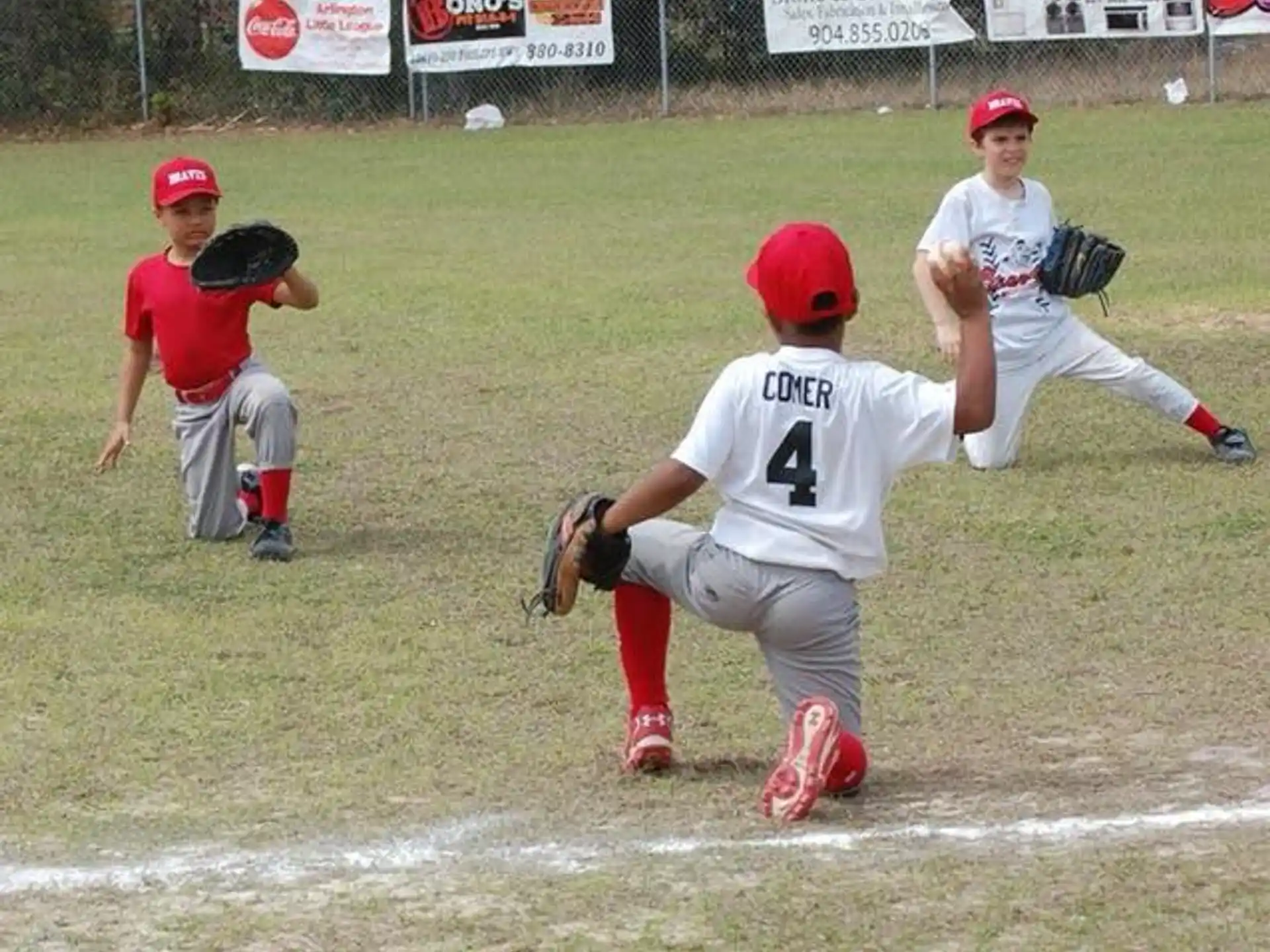 kids playing baseball on a field