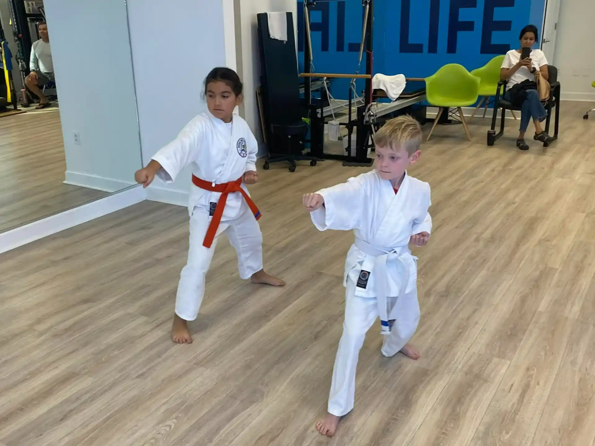 a couple of kids in karate uniforms