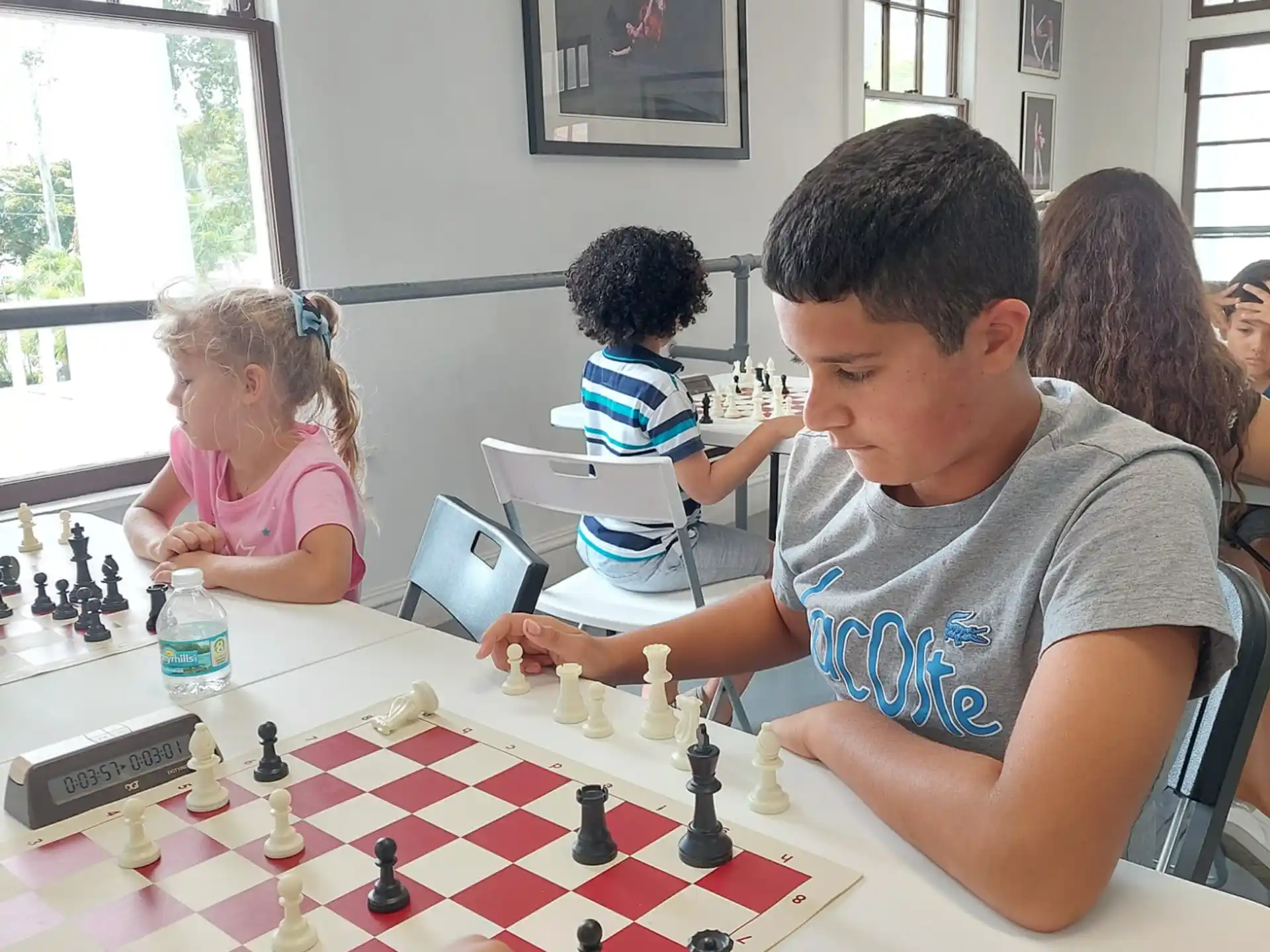 a person playing chess in a room with other people