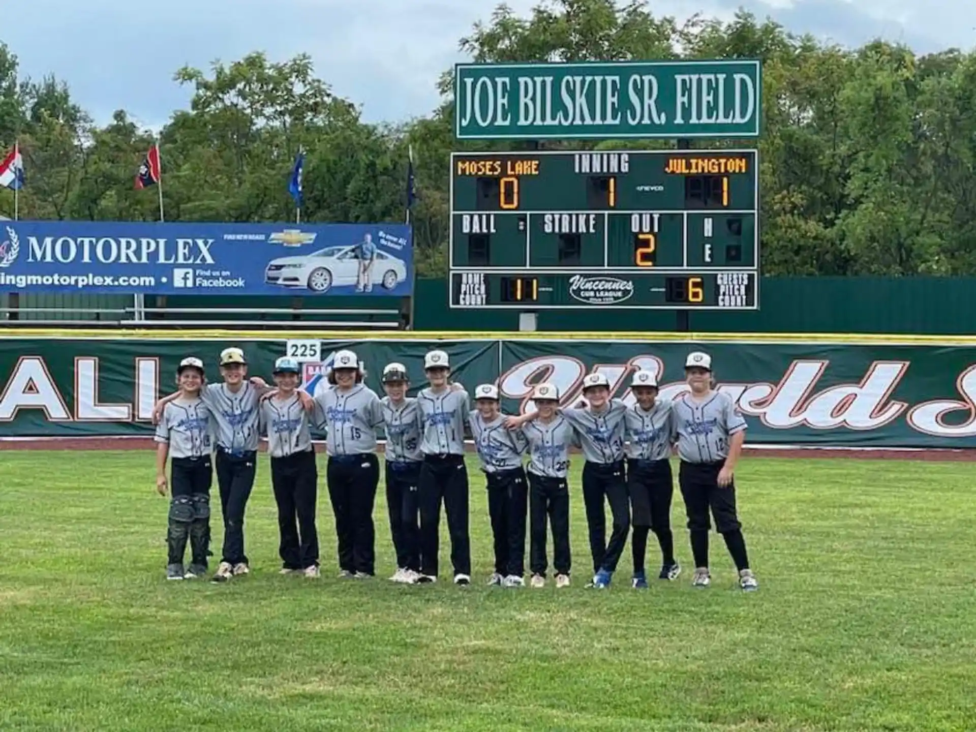 a group of people in uniform standing in front of a sign