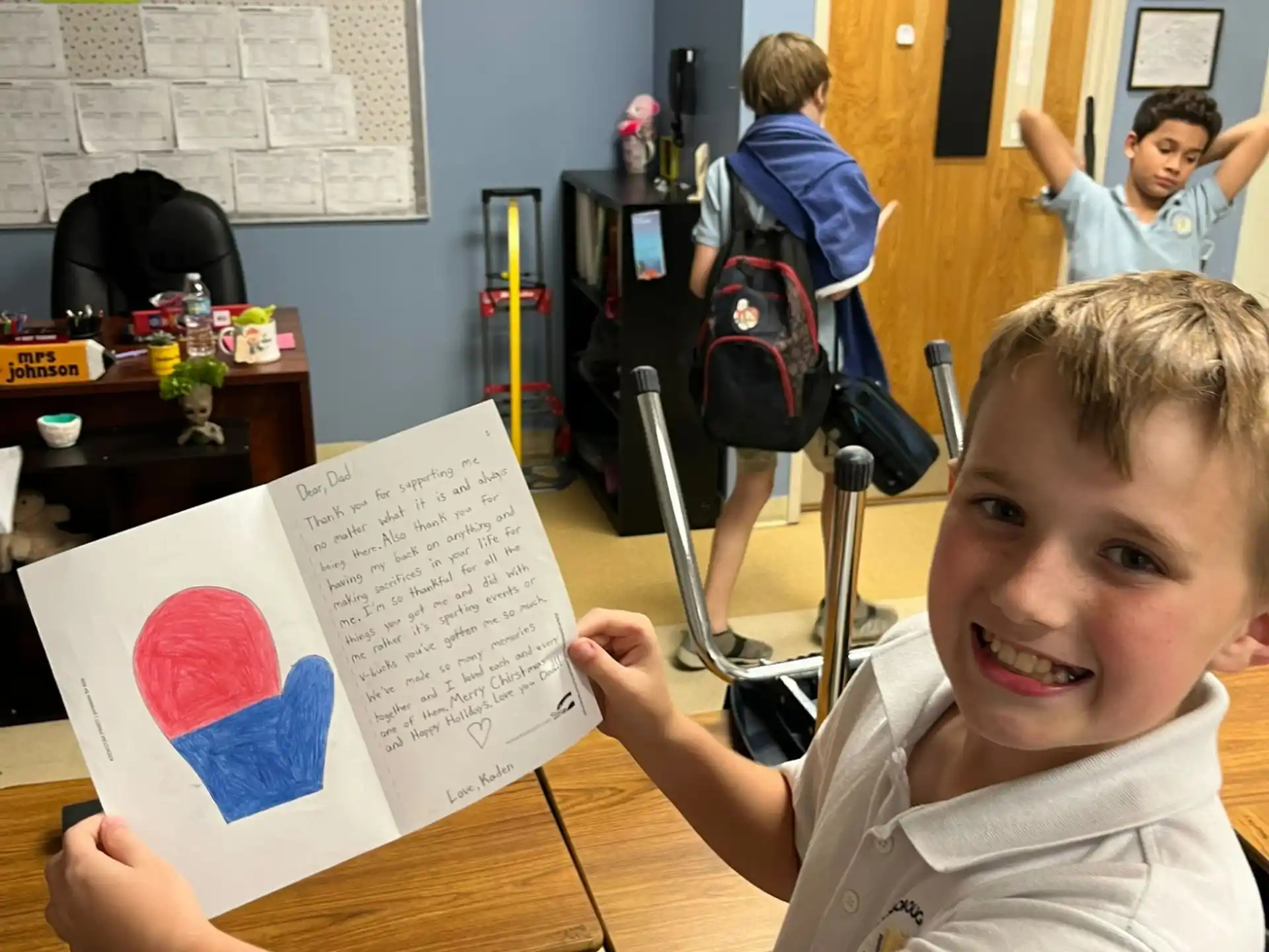 a boy holding a paper
