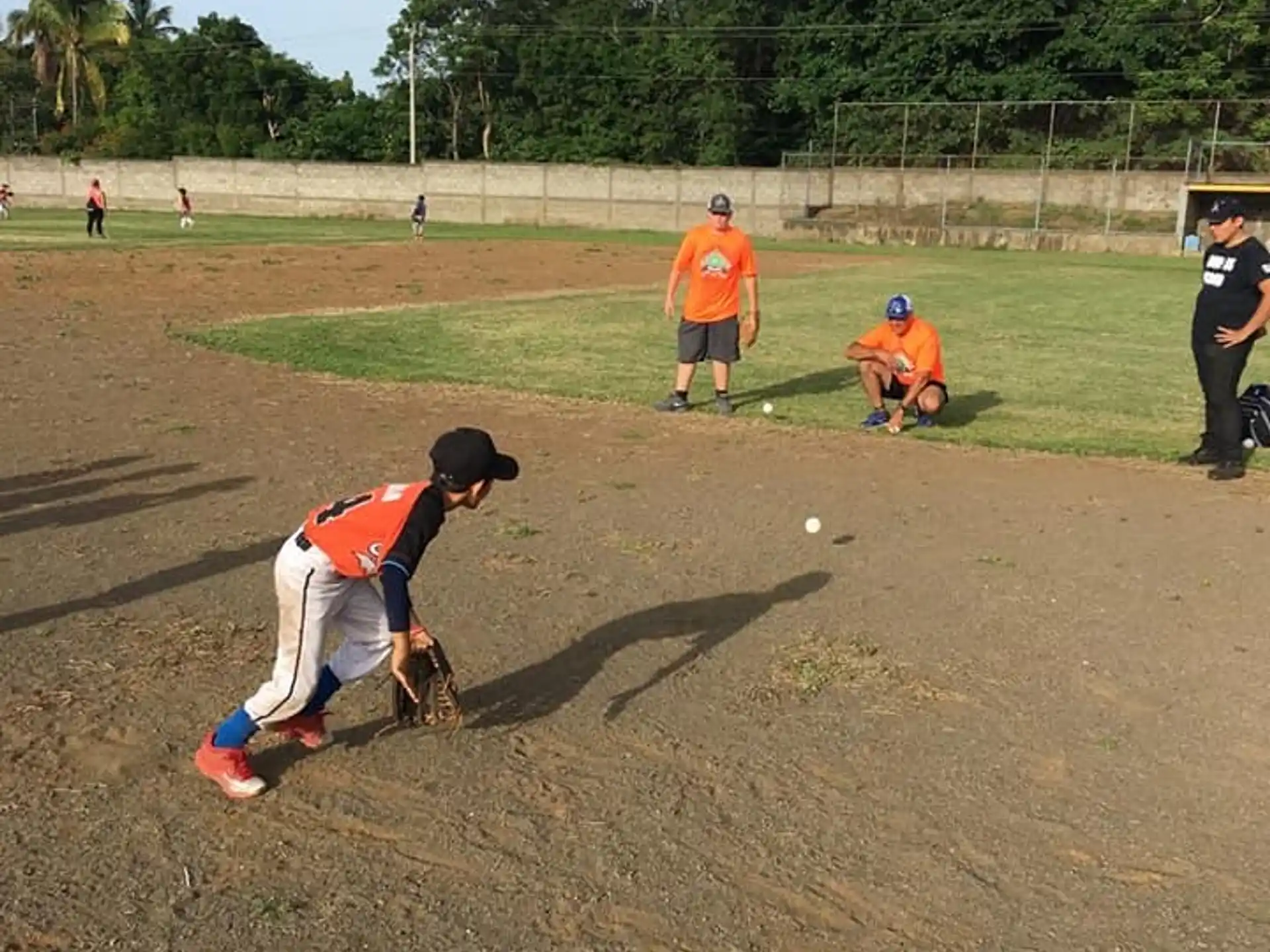 a group of people playing baseball