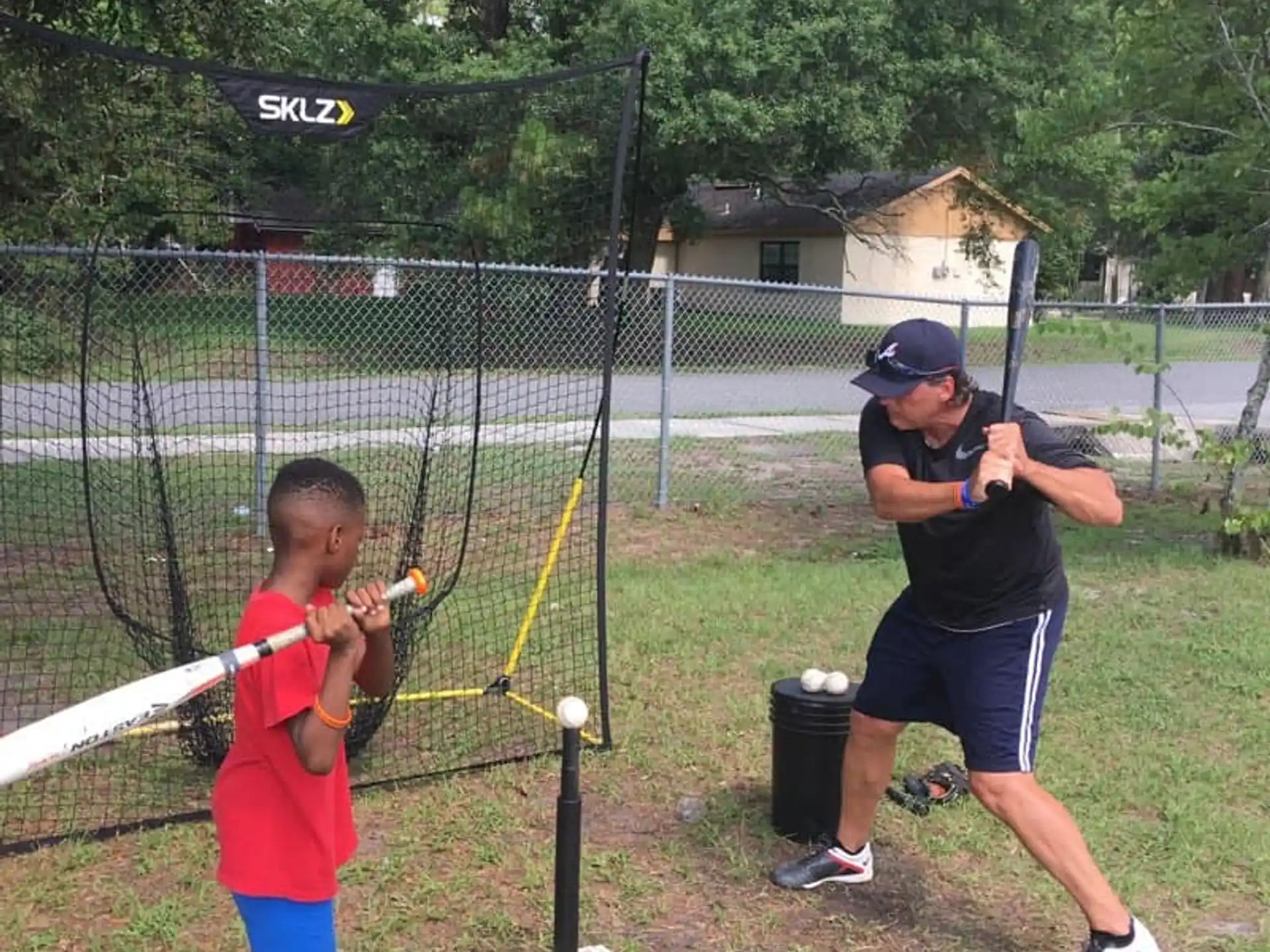 a person and a boy playing baseball