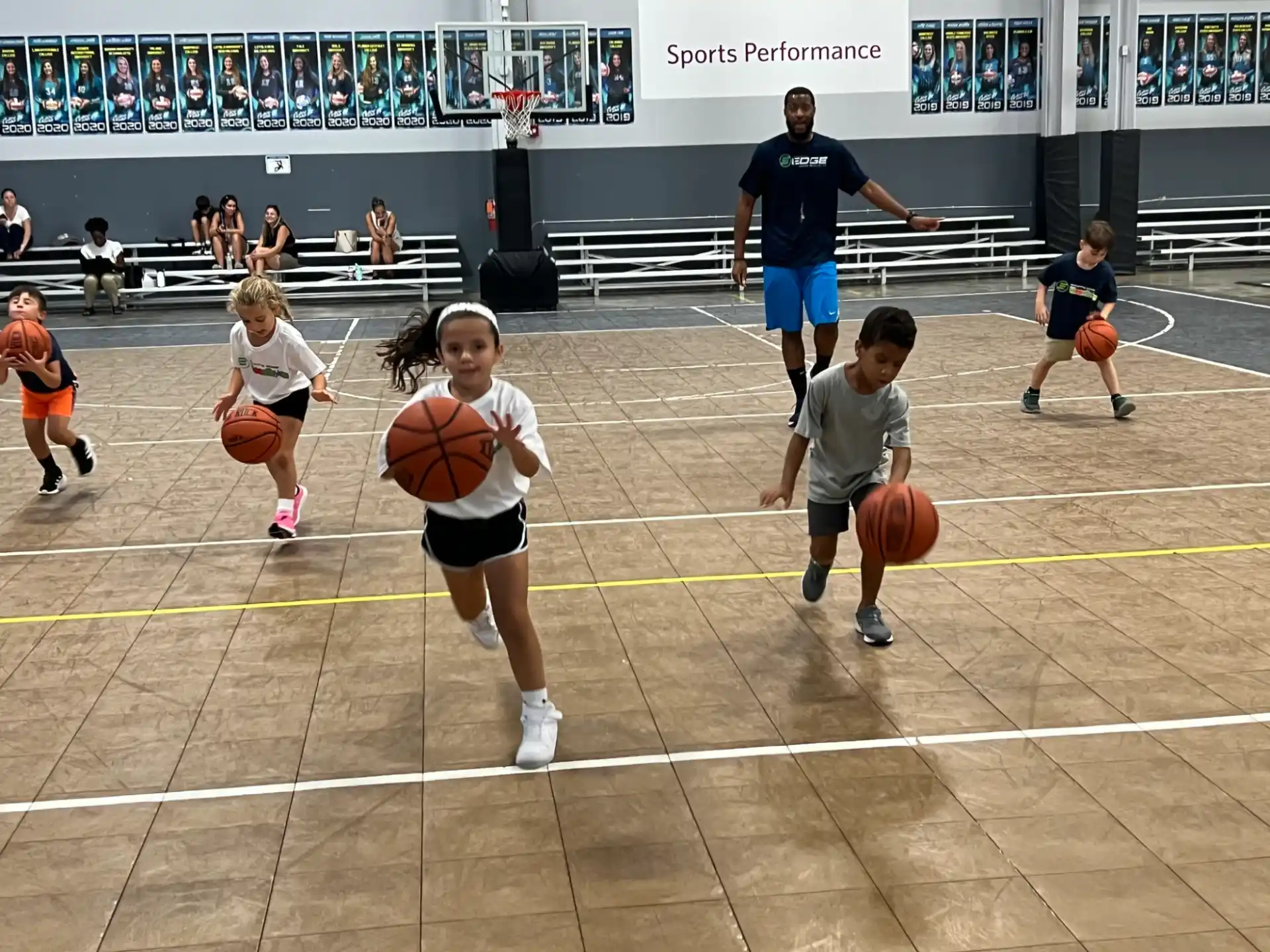 a group of kids playing basketball