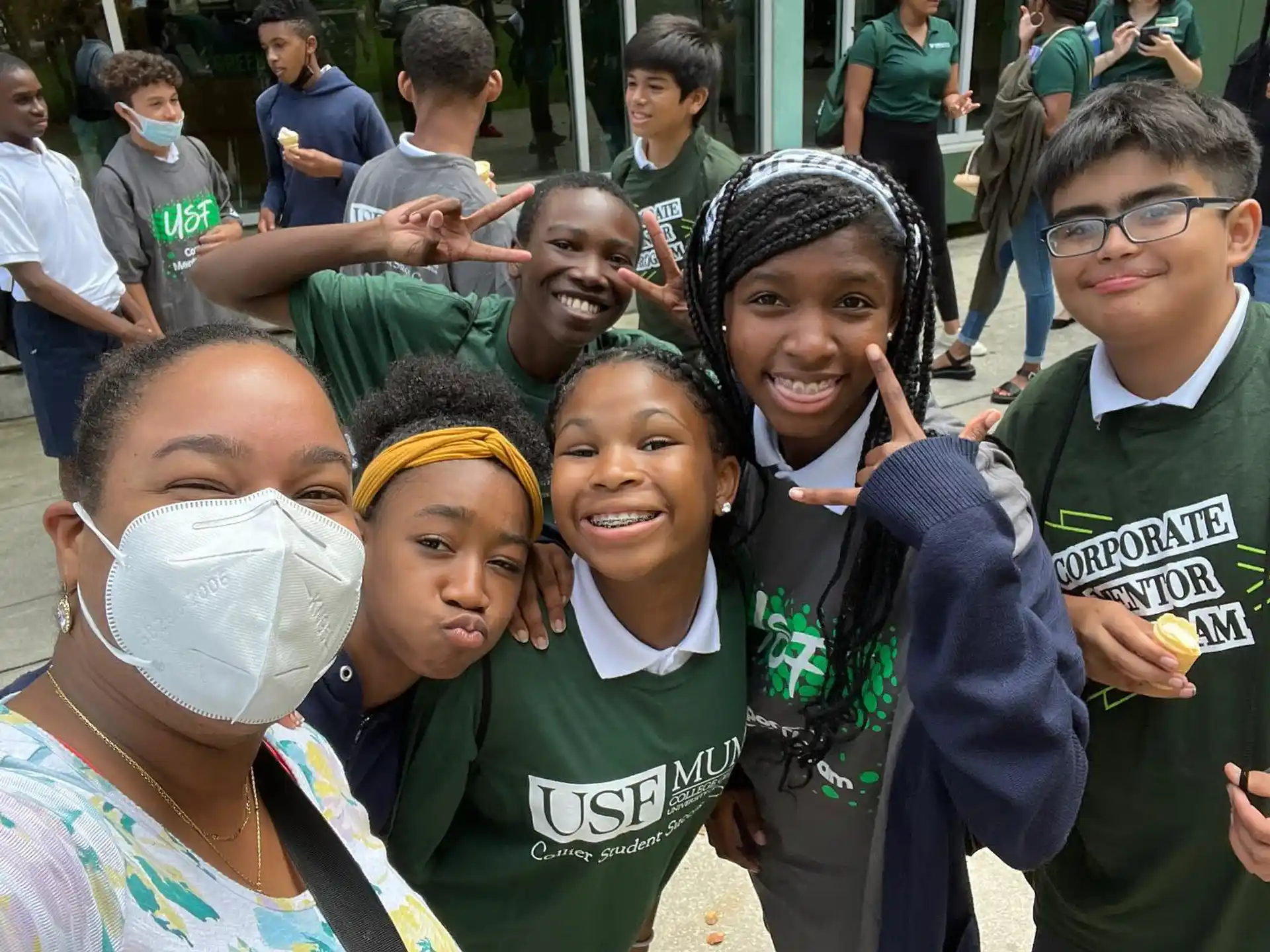 a group of people wearing green shirts