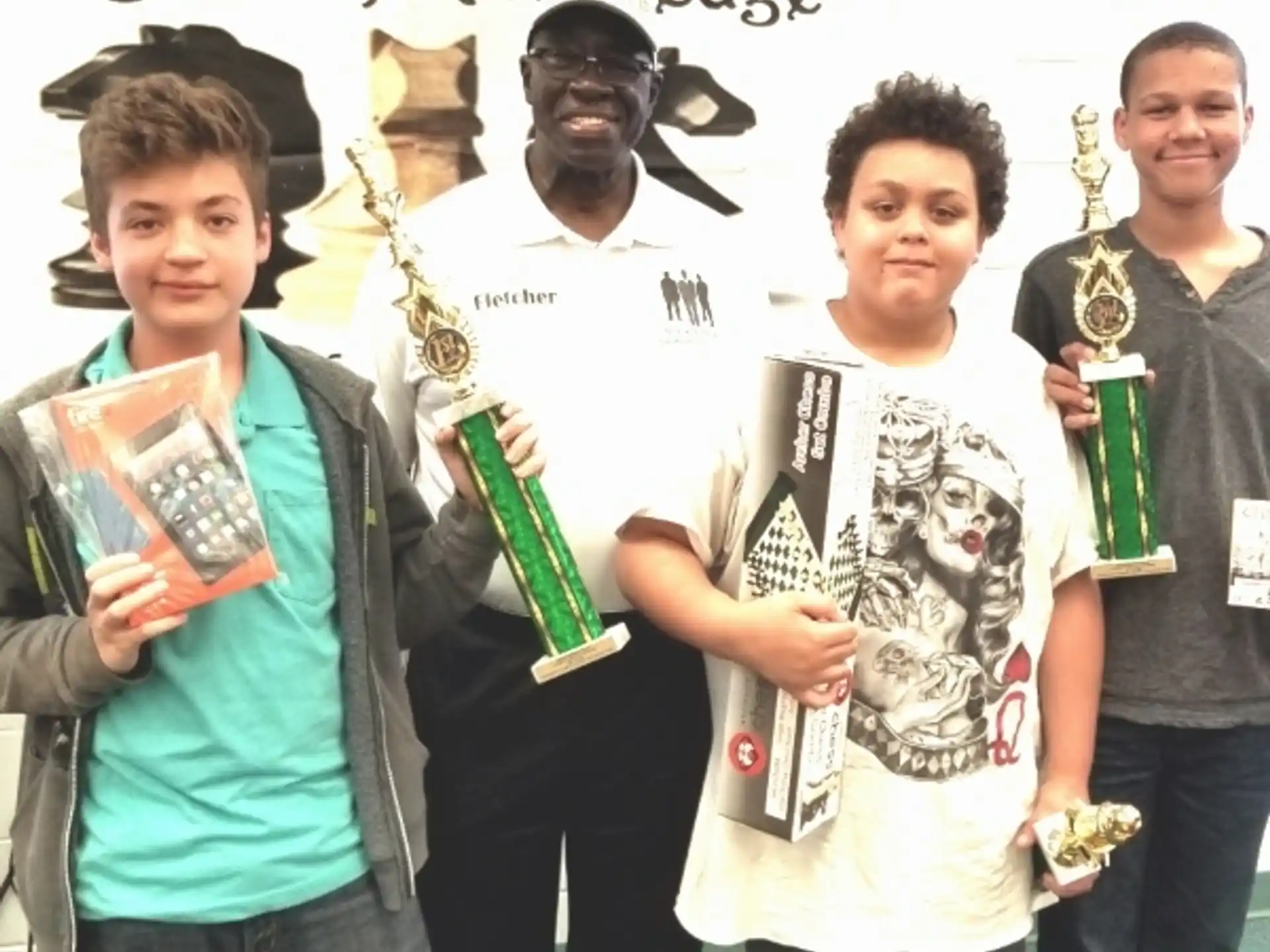 a group of men holding trophies