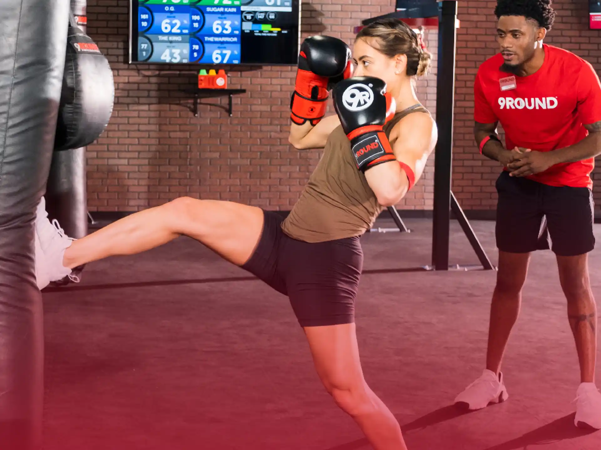 a woman lifting a man in a boxing ring