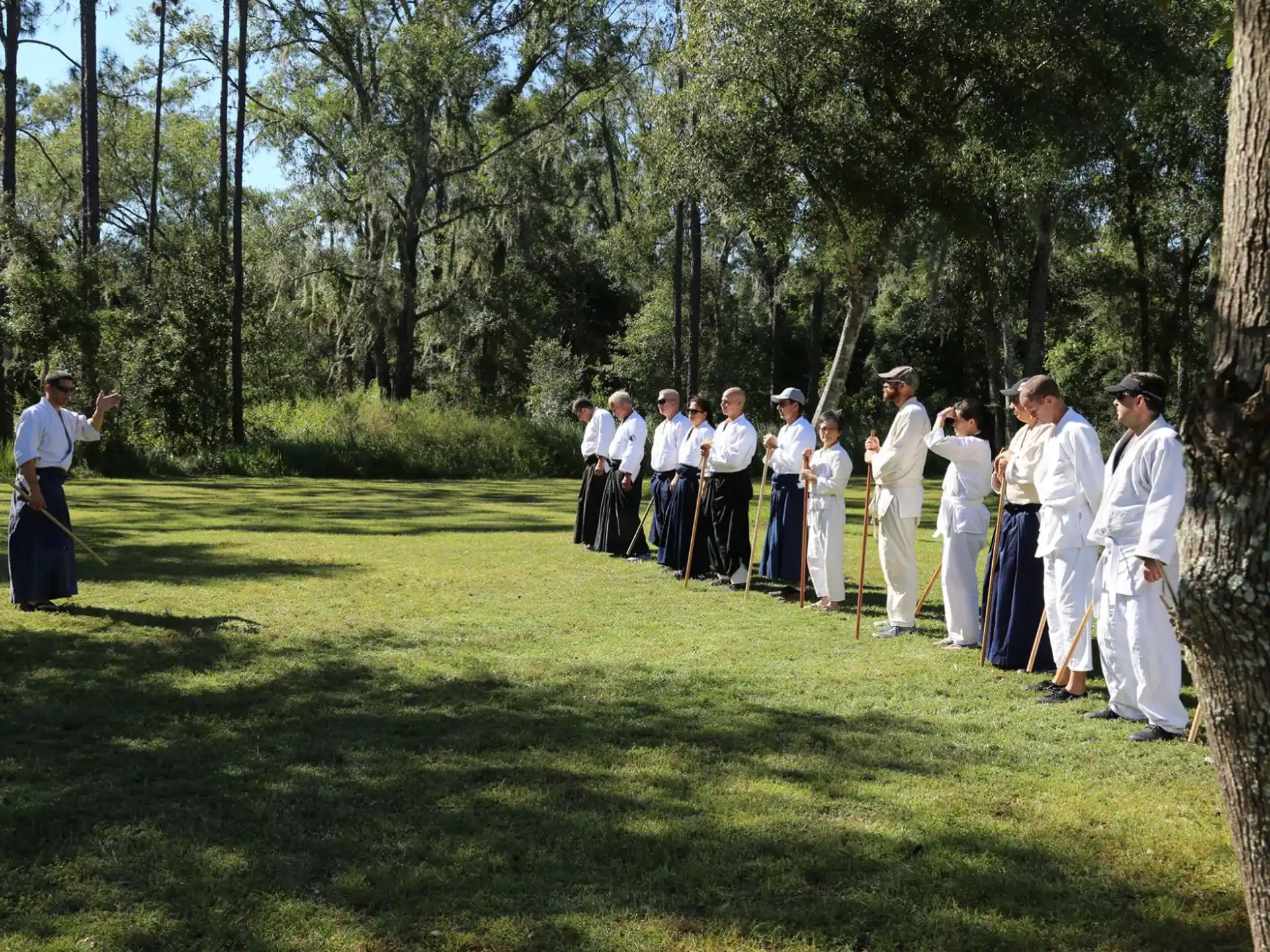 a group of people in white robes standing on a golf course