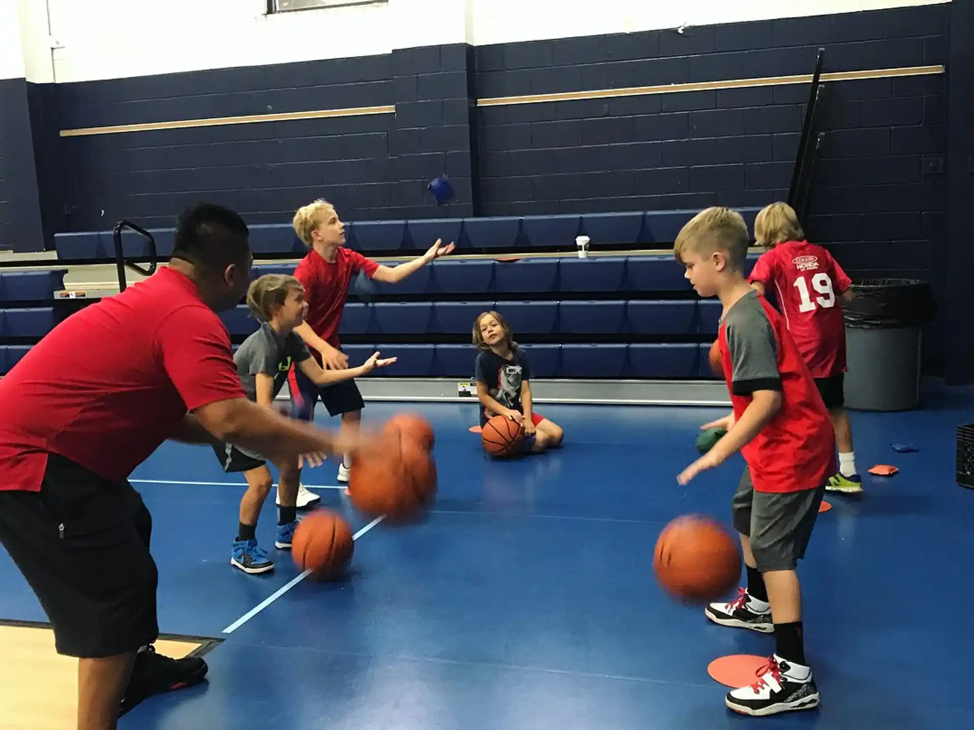 a group of people playing basketball