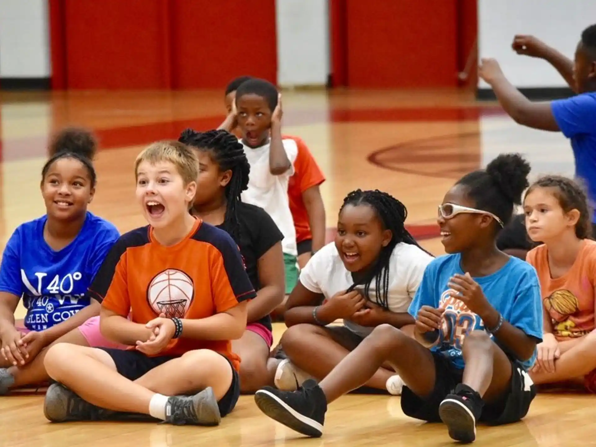 a group of kids sitting on the floor