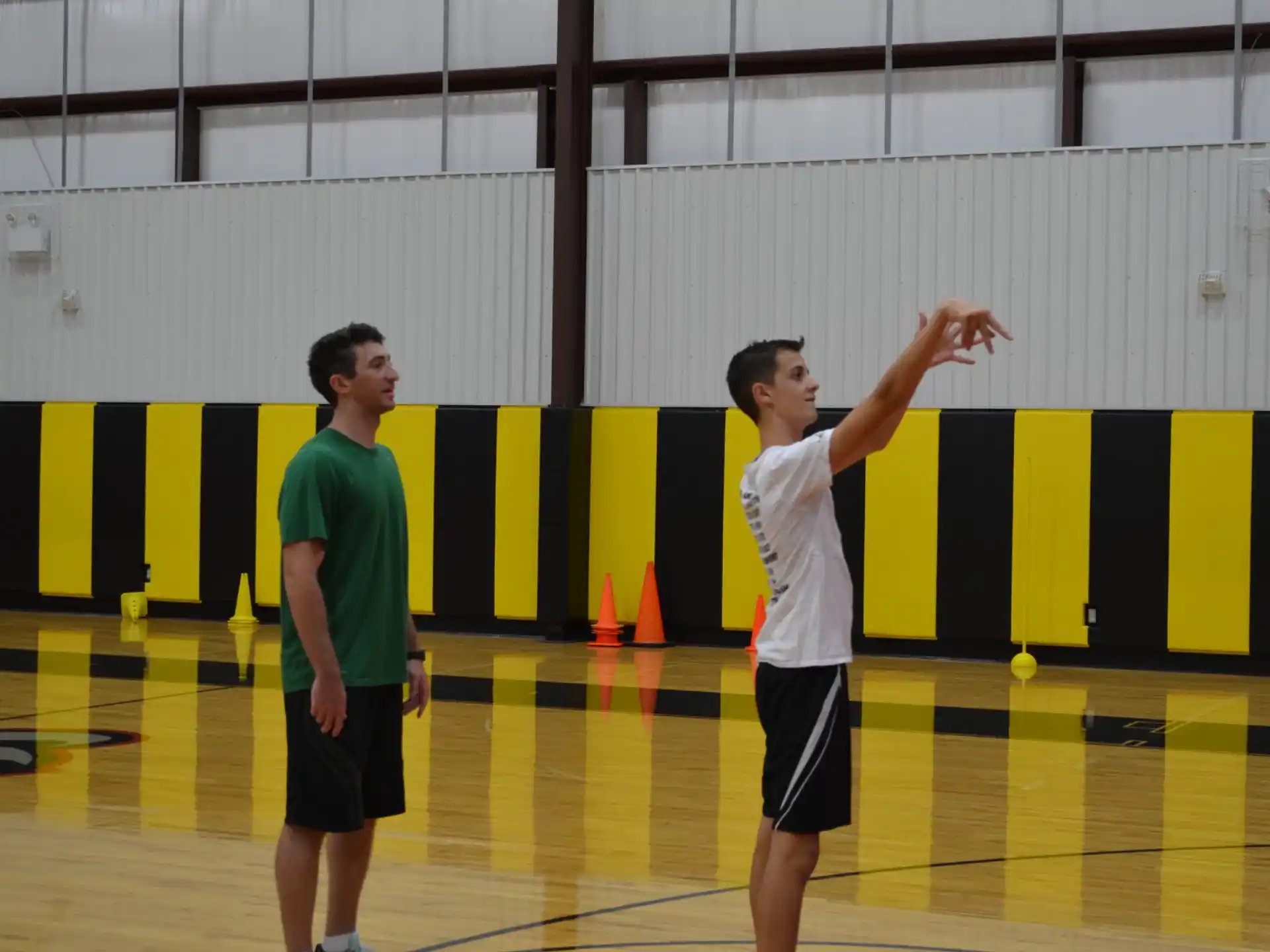 a couple of men playing basketball