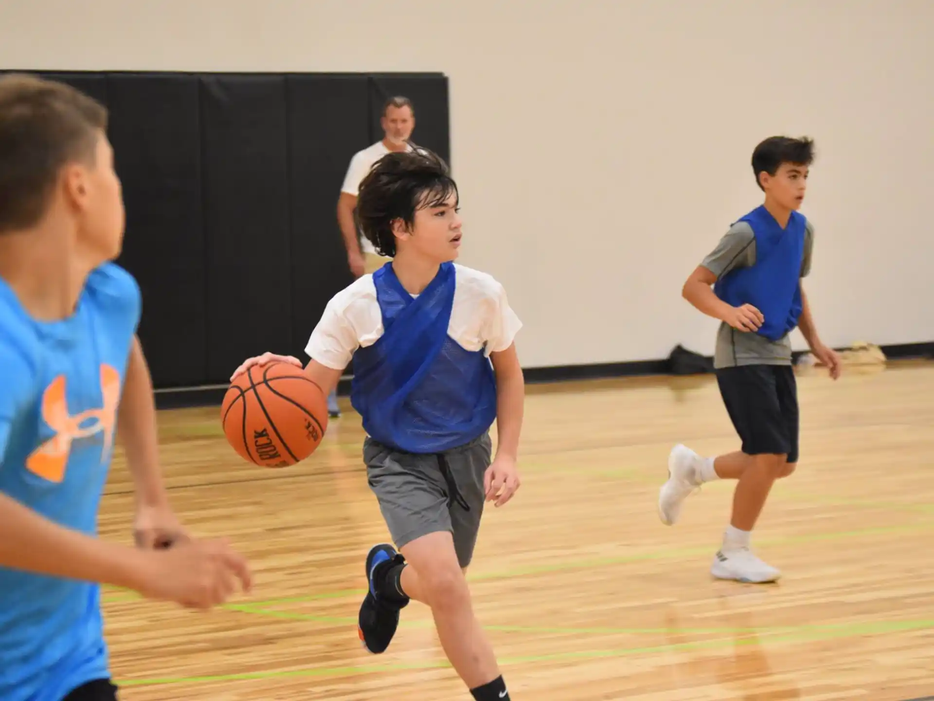 a group of boys playing basketball