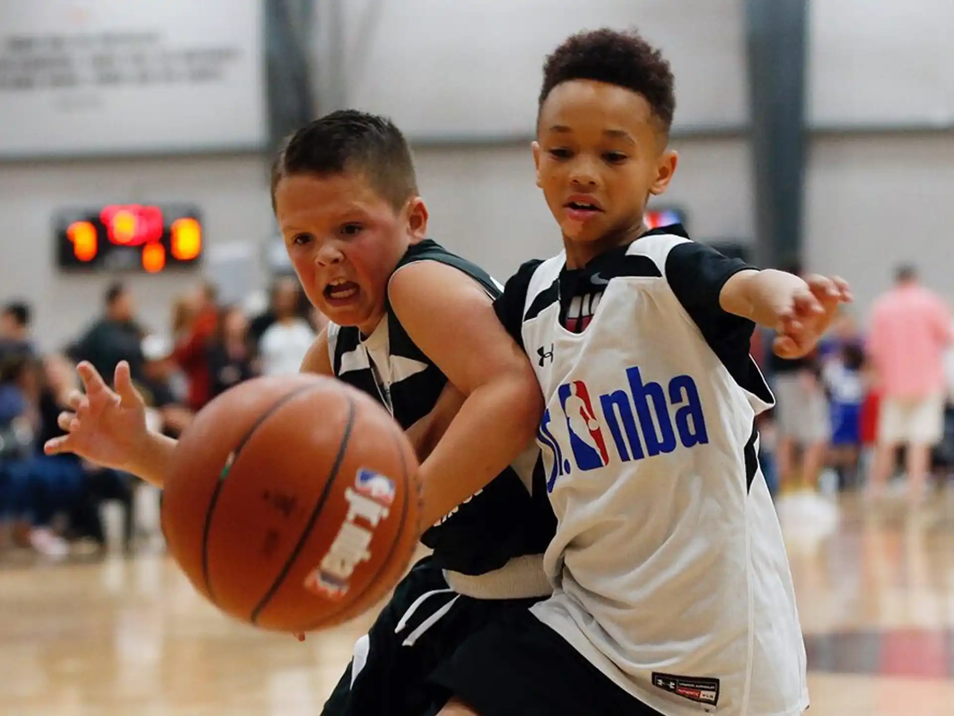 a couple of boys playing basketball