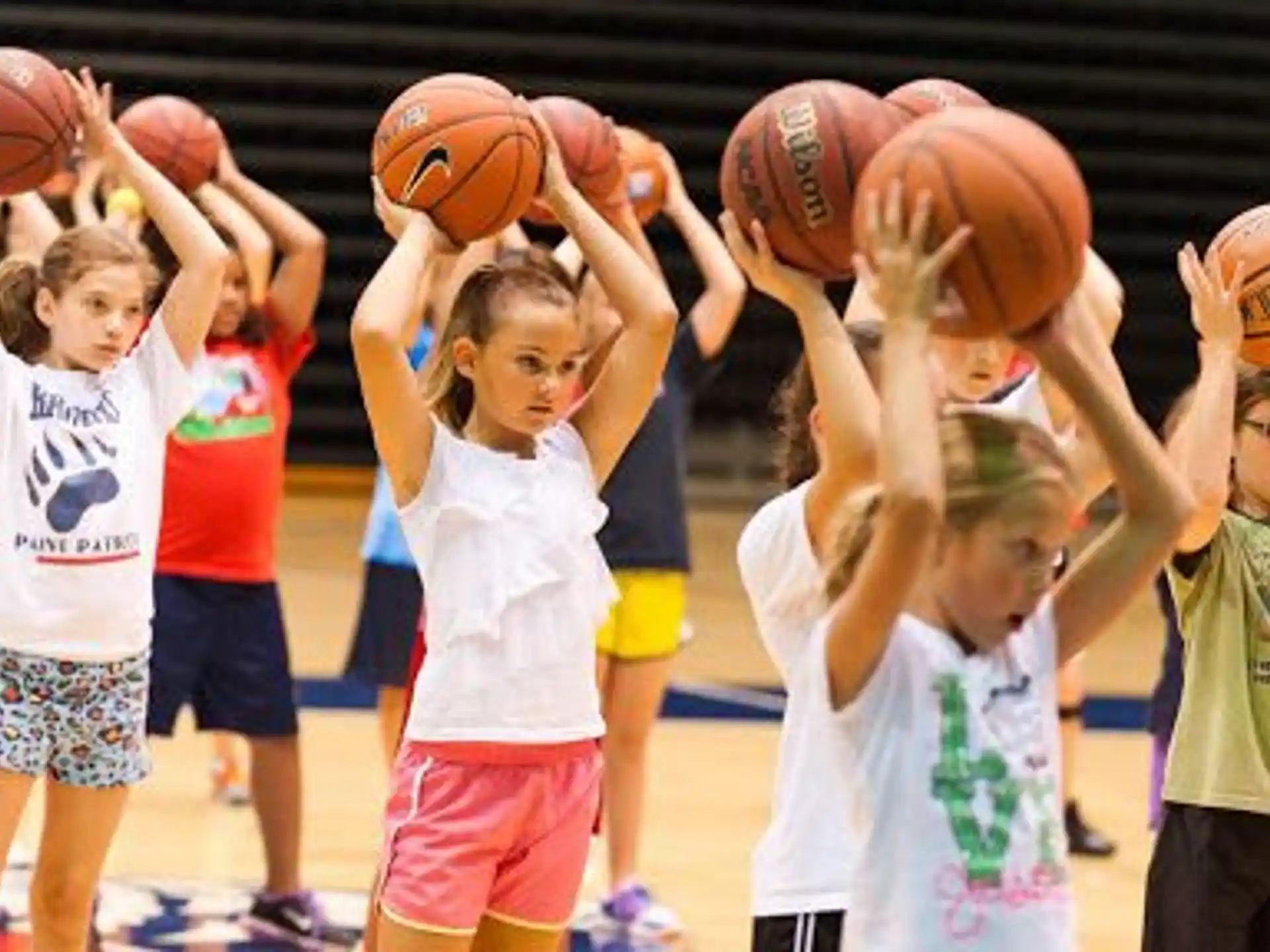 a group of kids holding basketballs