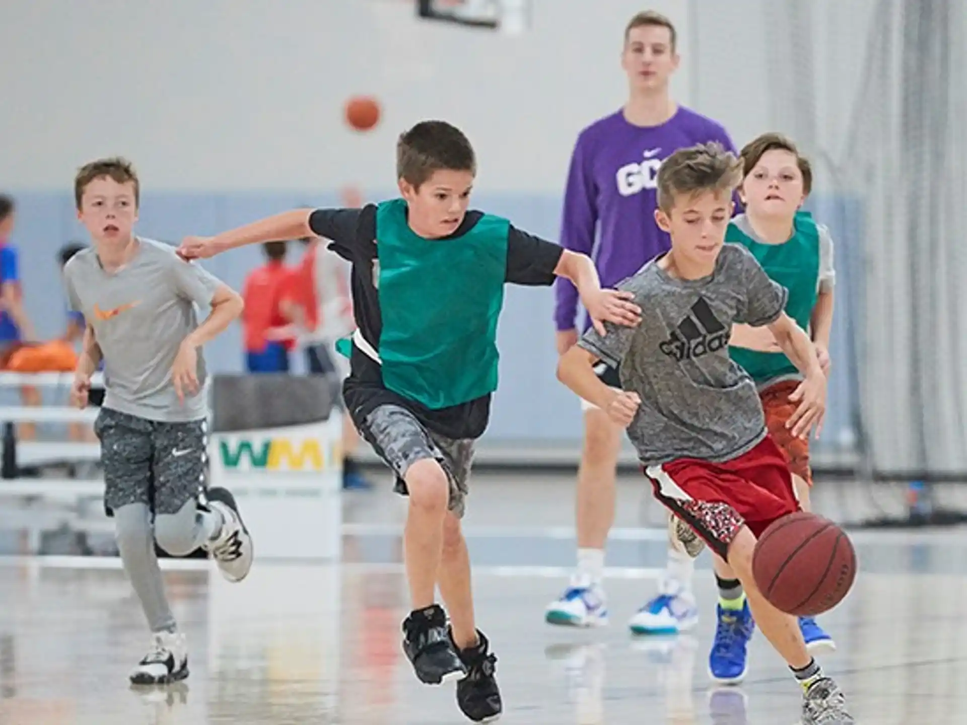 a group of kids playing basketball