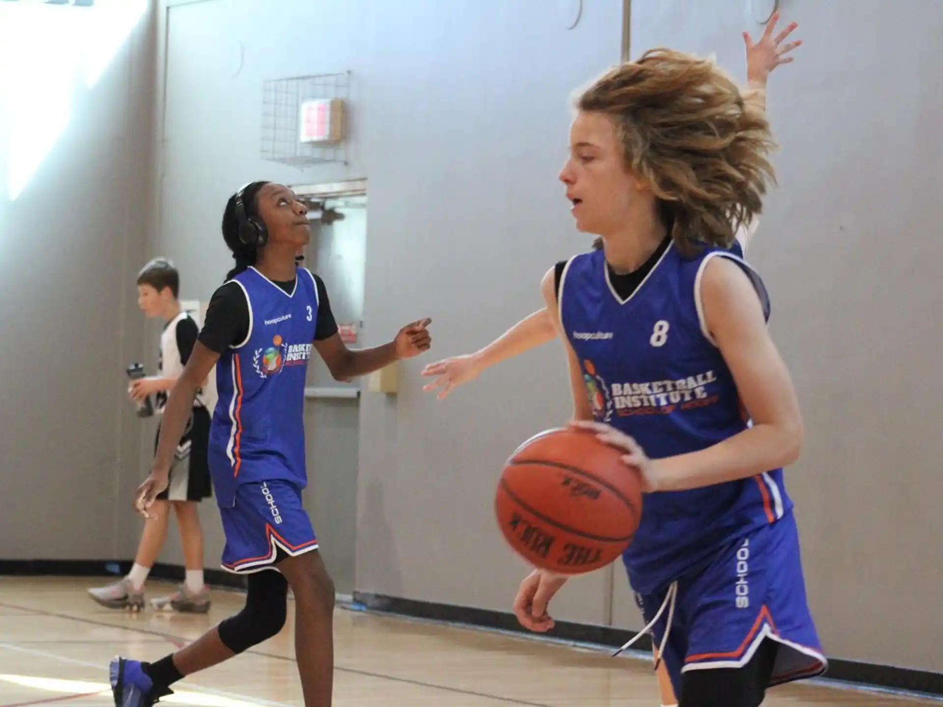 a group of women playing basketball
