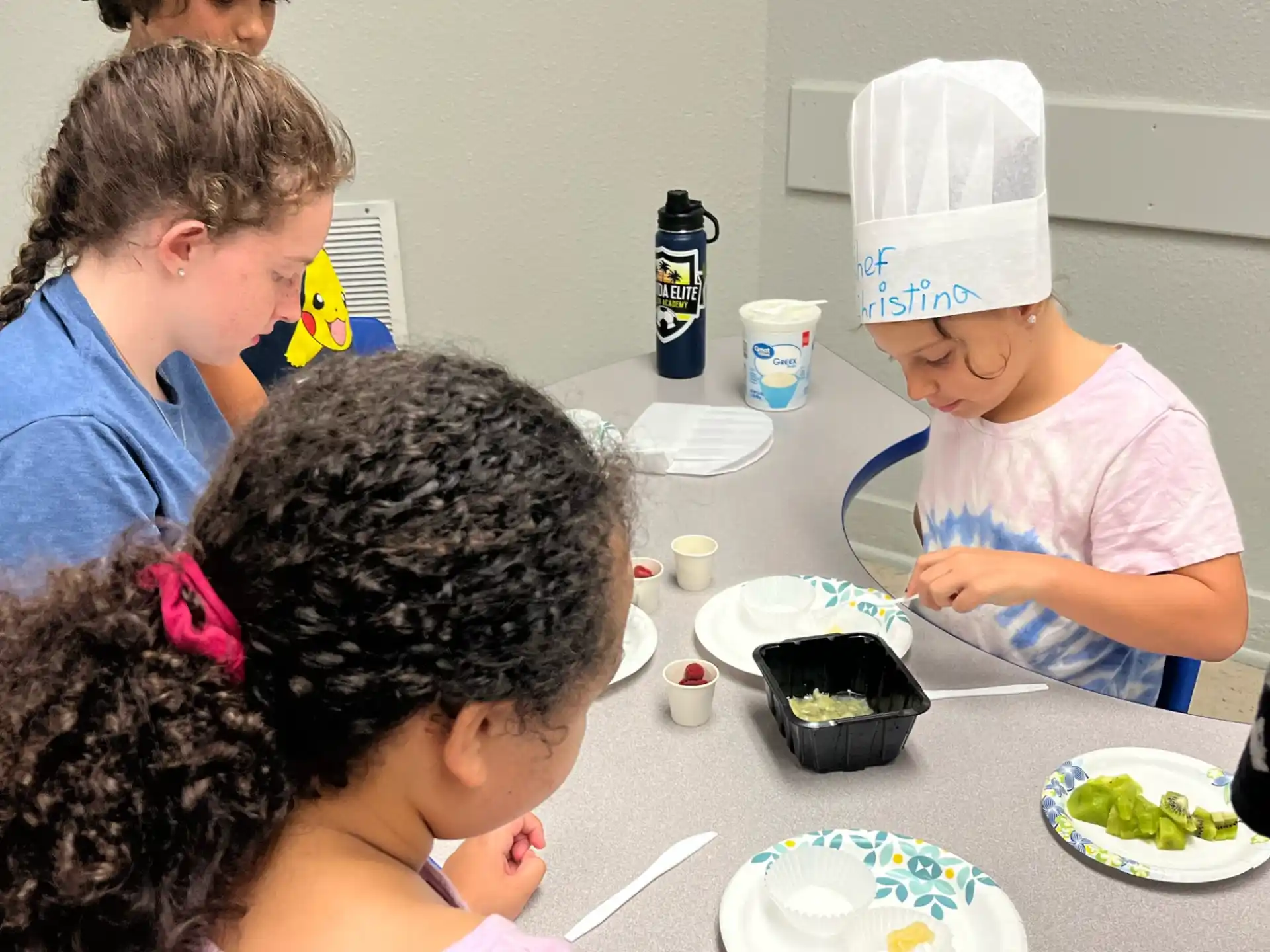 a group of children eating at a table