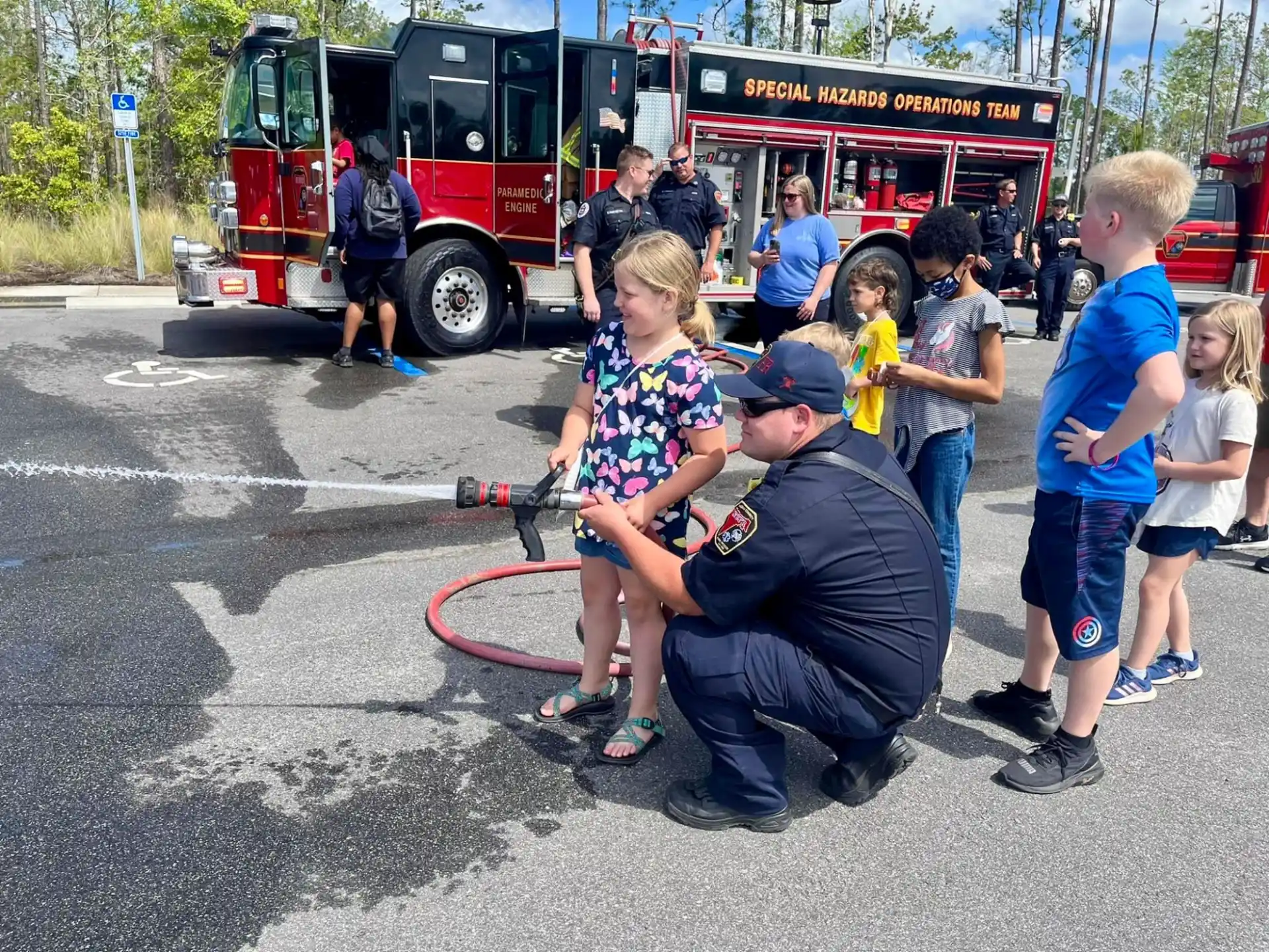 a group of people standing around a firetruck