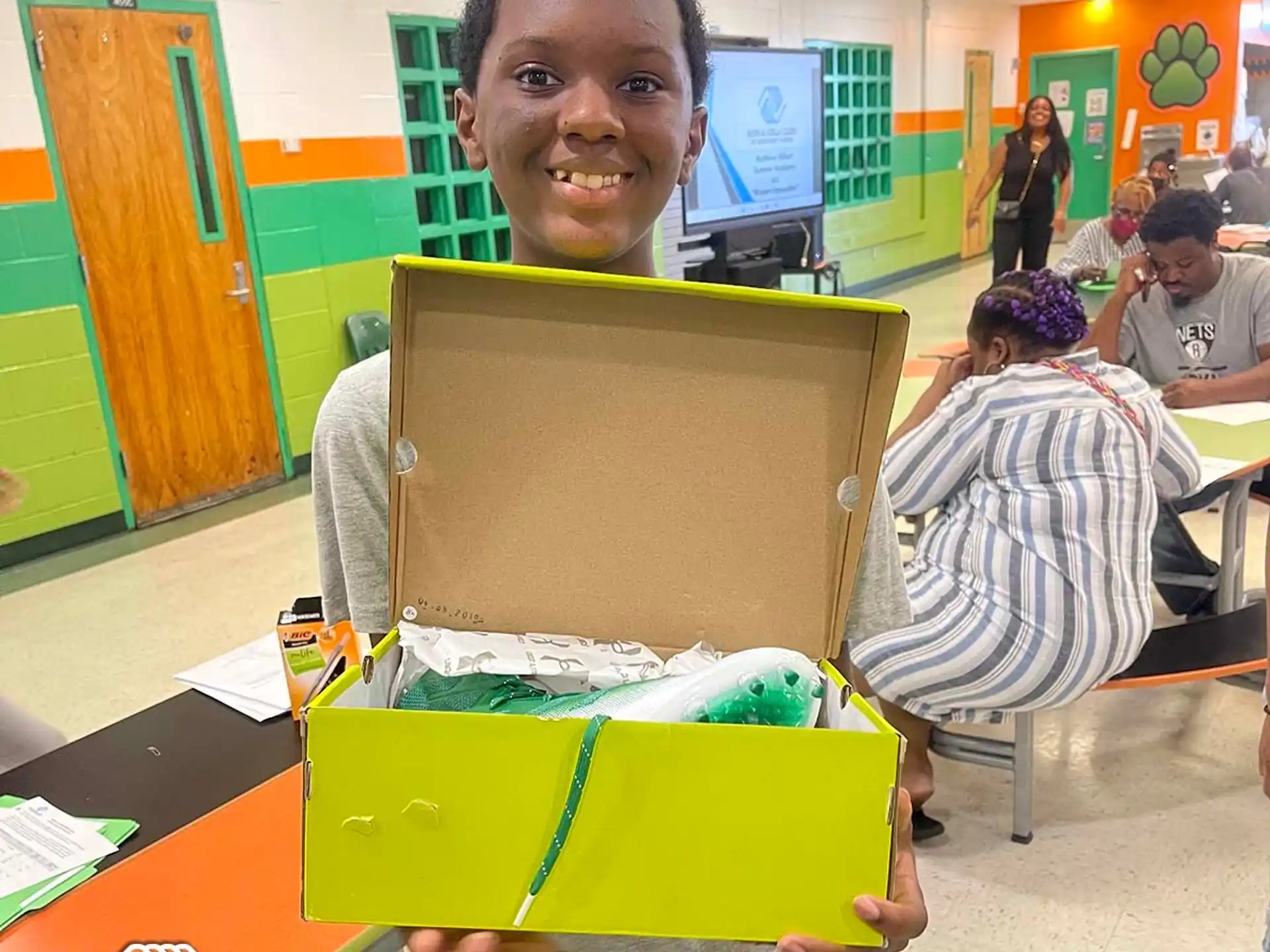 a boy holding a box