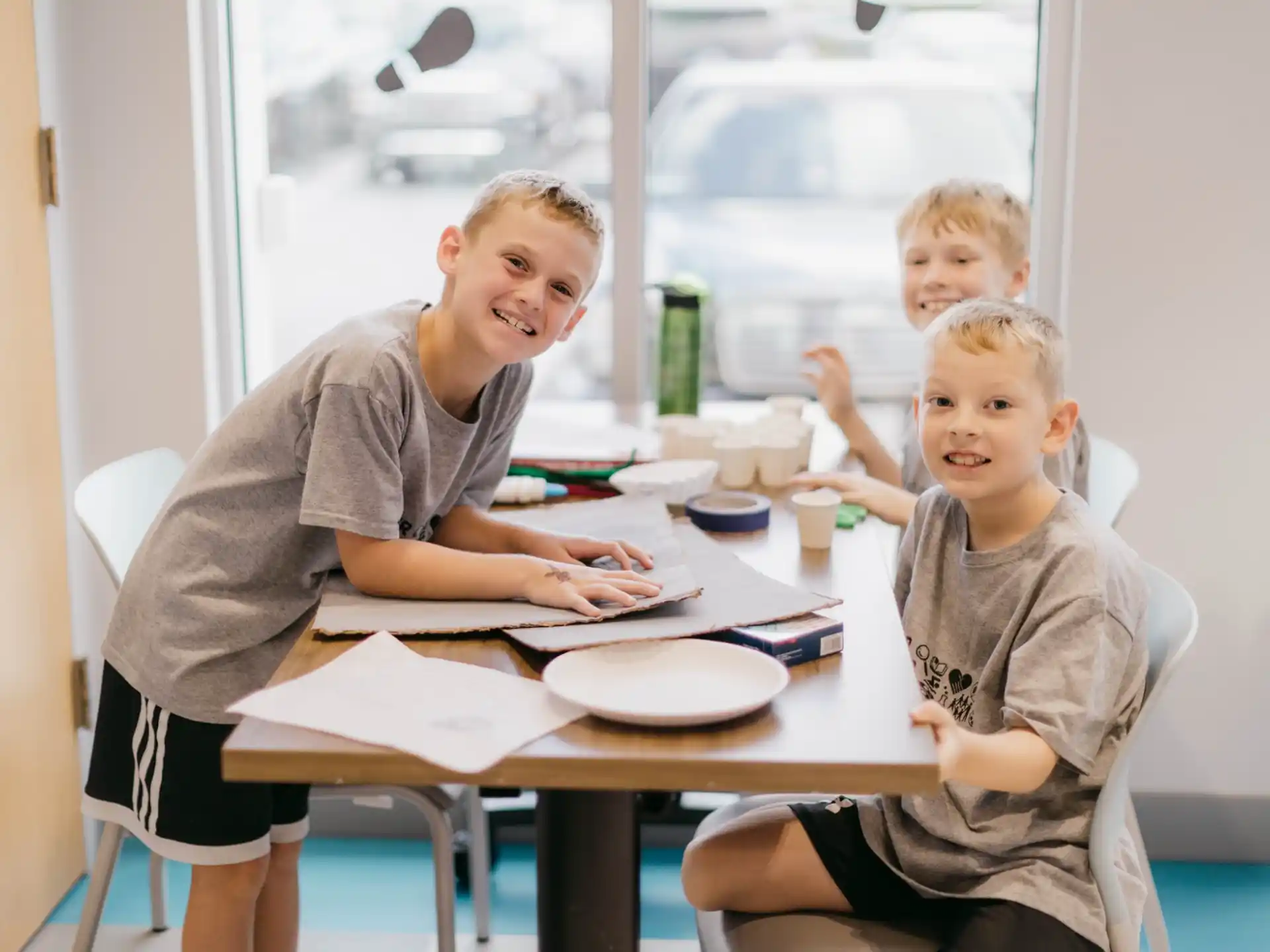 a person and two children sitting at a table