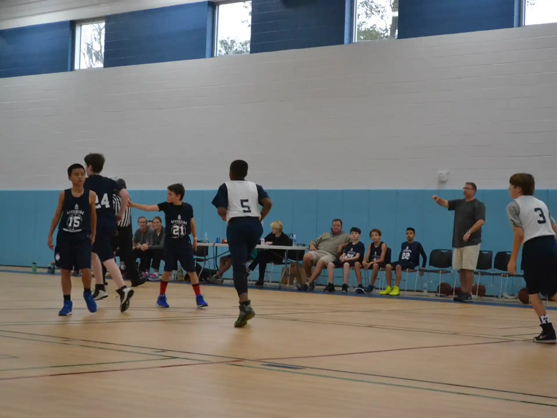 a group of people playing basketball