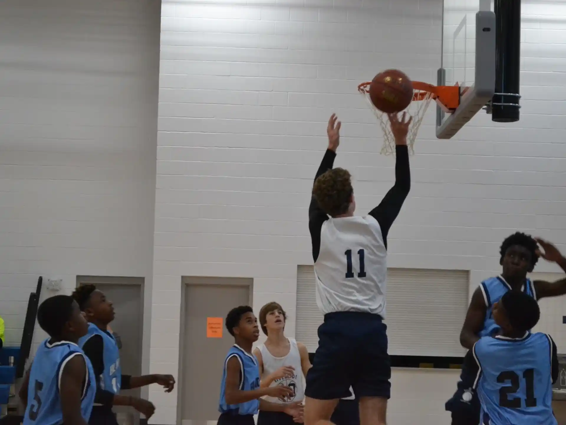a group of people playing basketball