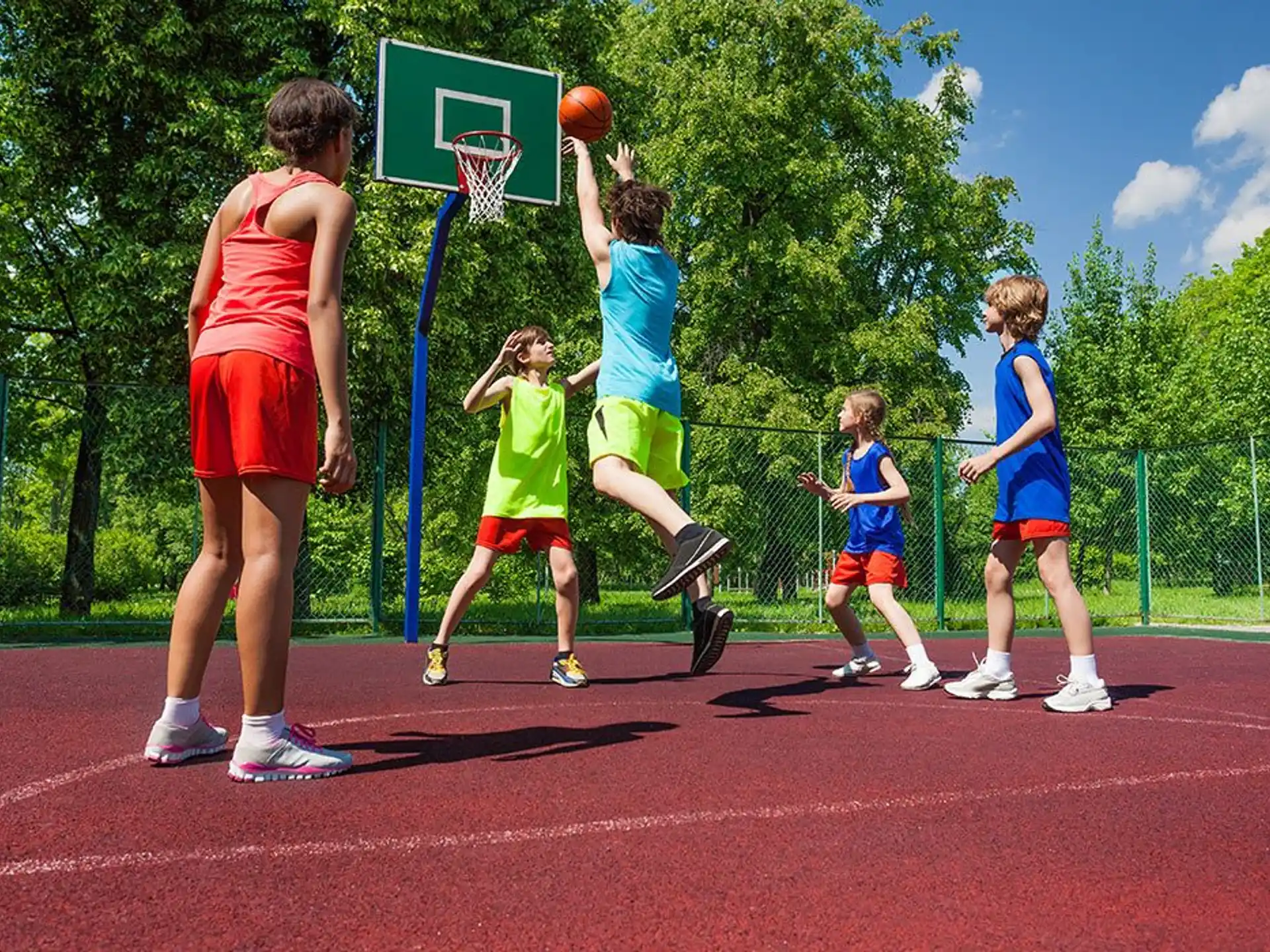 a group of kids playing basketball