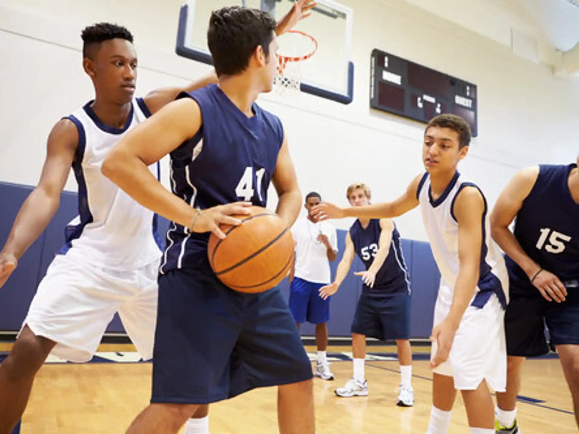 a group of people playing basketball
