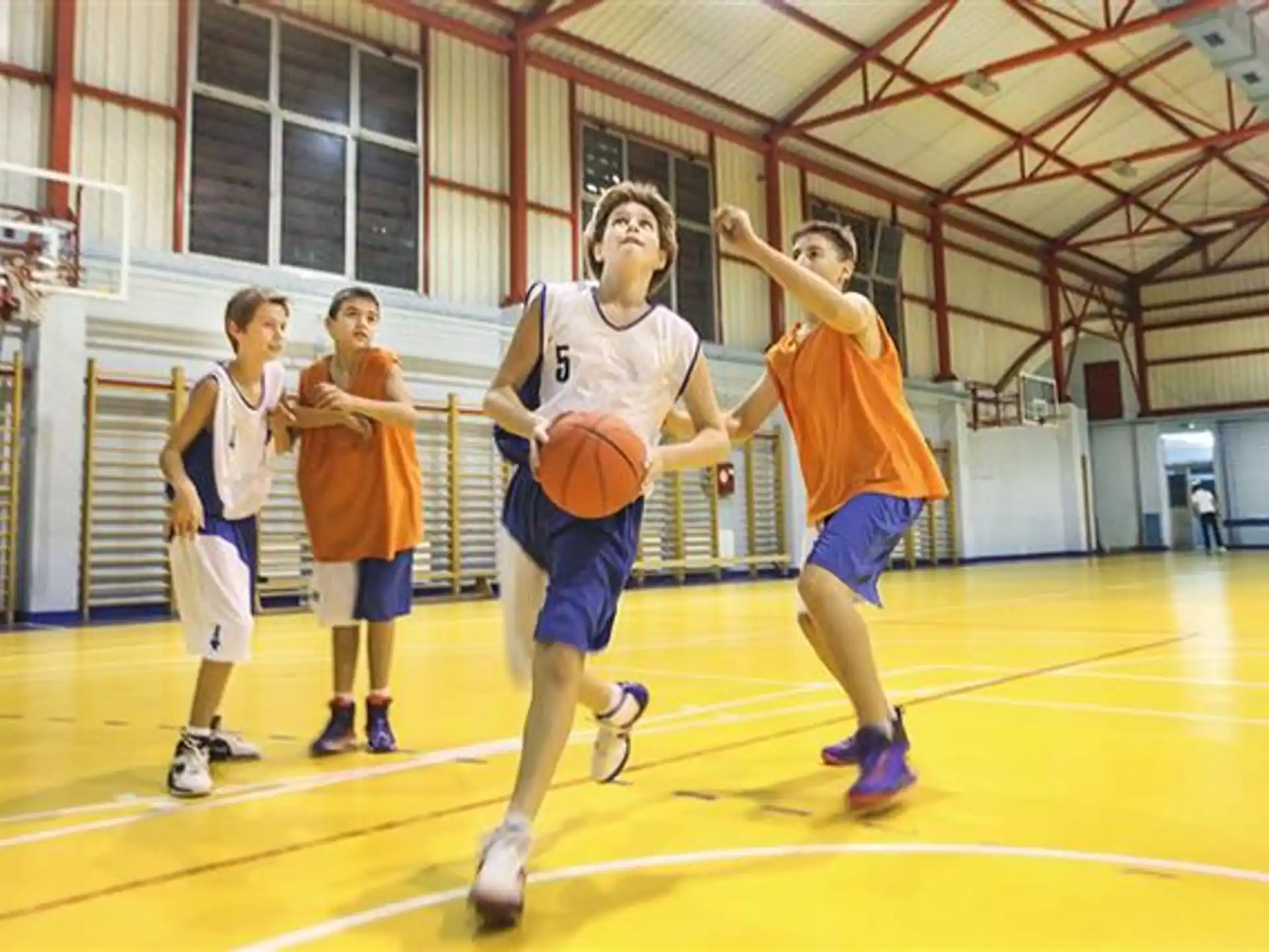 a group of people playing basketball