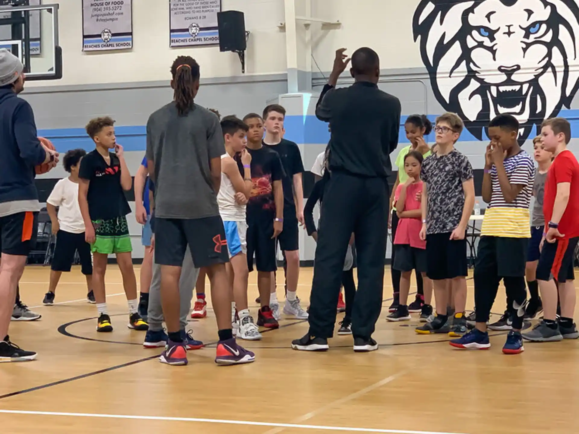 a group of people standing on a basketball court
