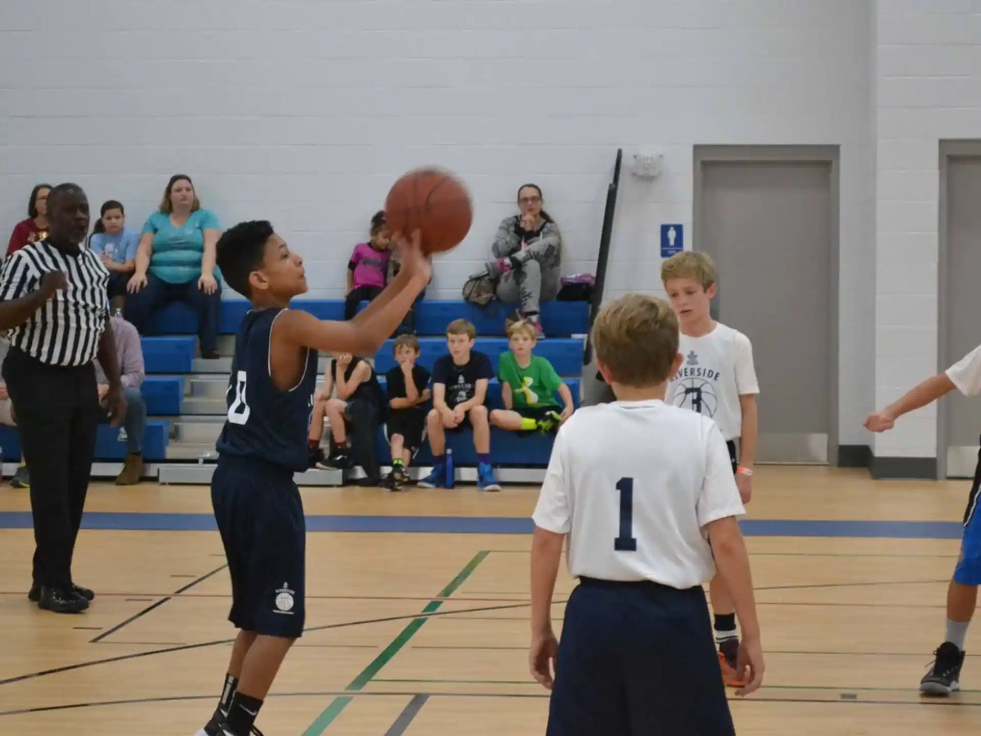 a group of kids playing basketball