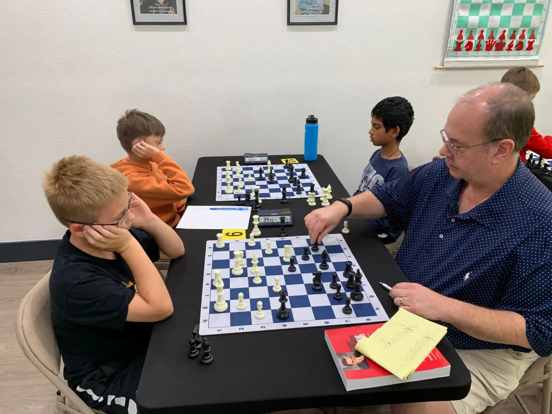 a group of people sitting around a table playing a board game