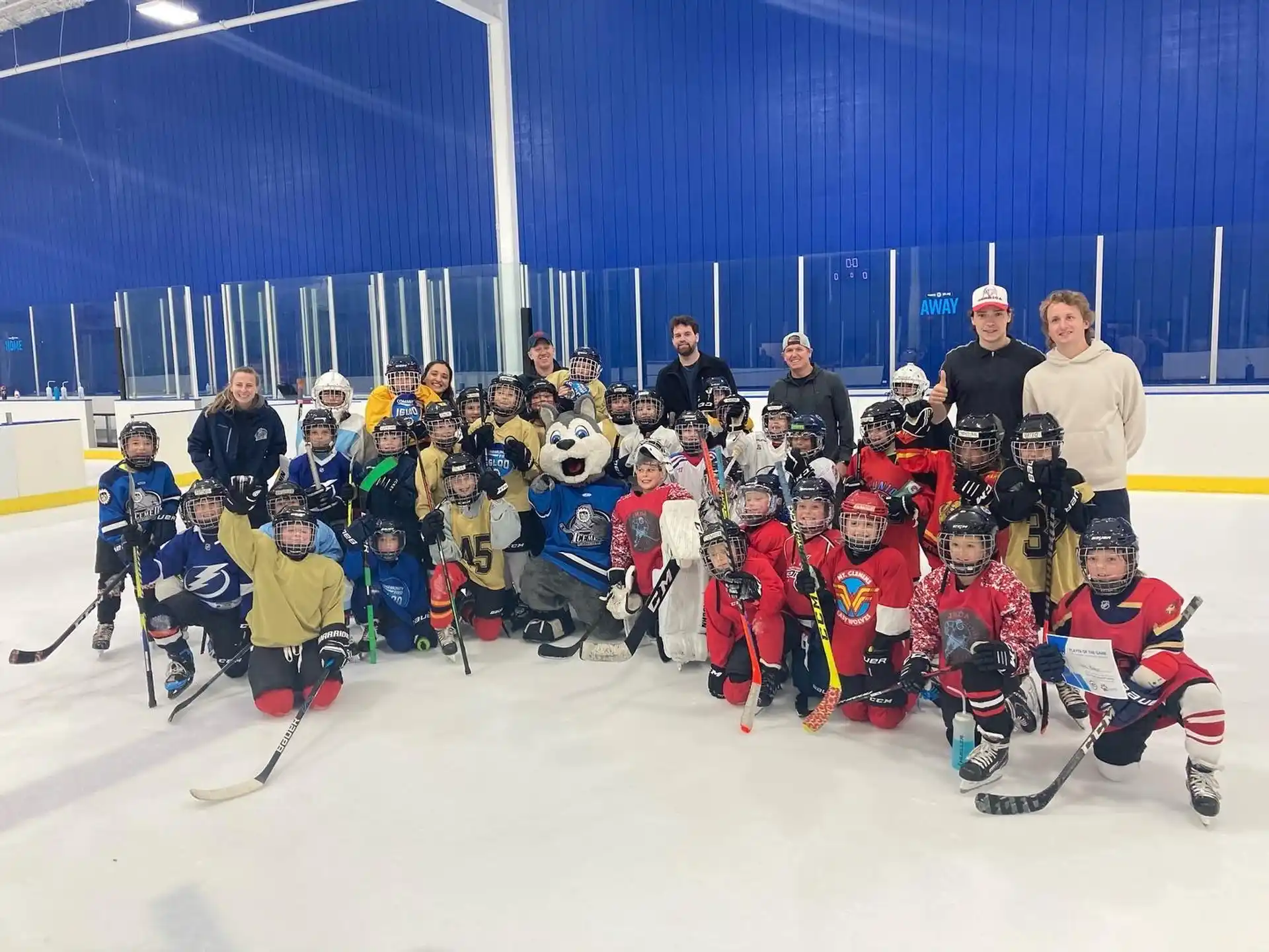 a group of people posing for a photo on ice