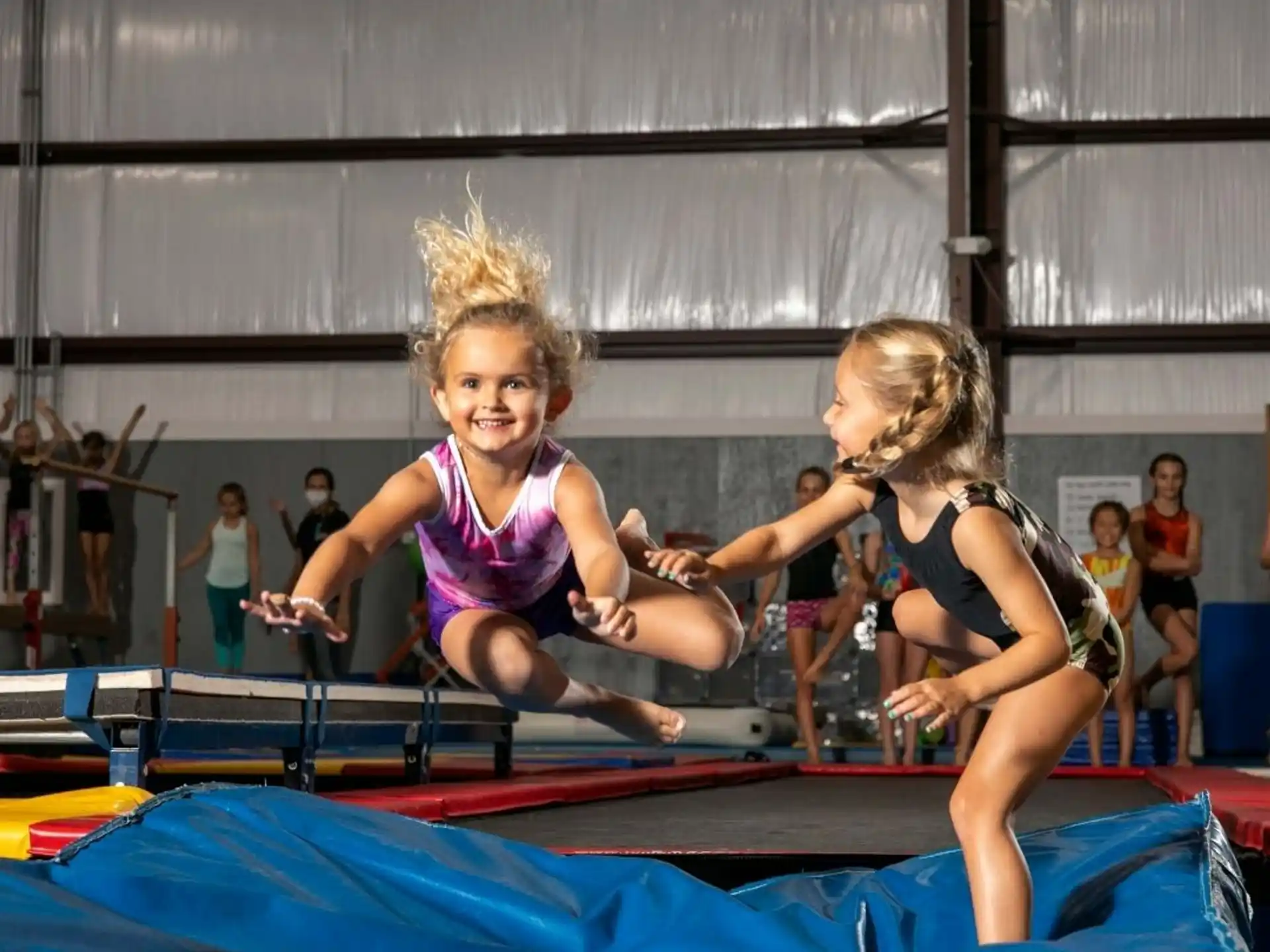a person and a girl on a trampoline