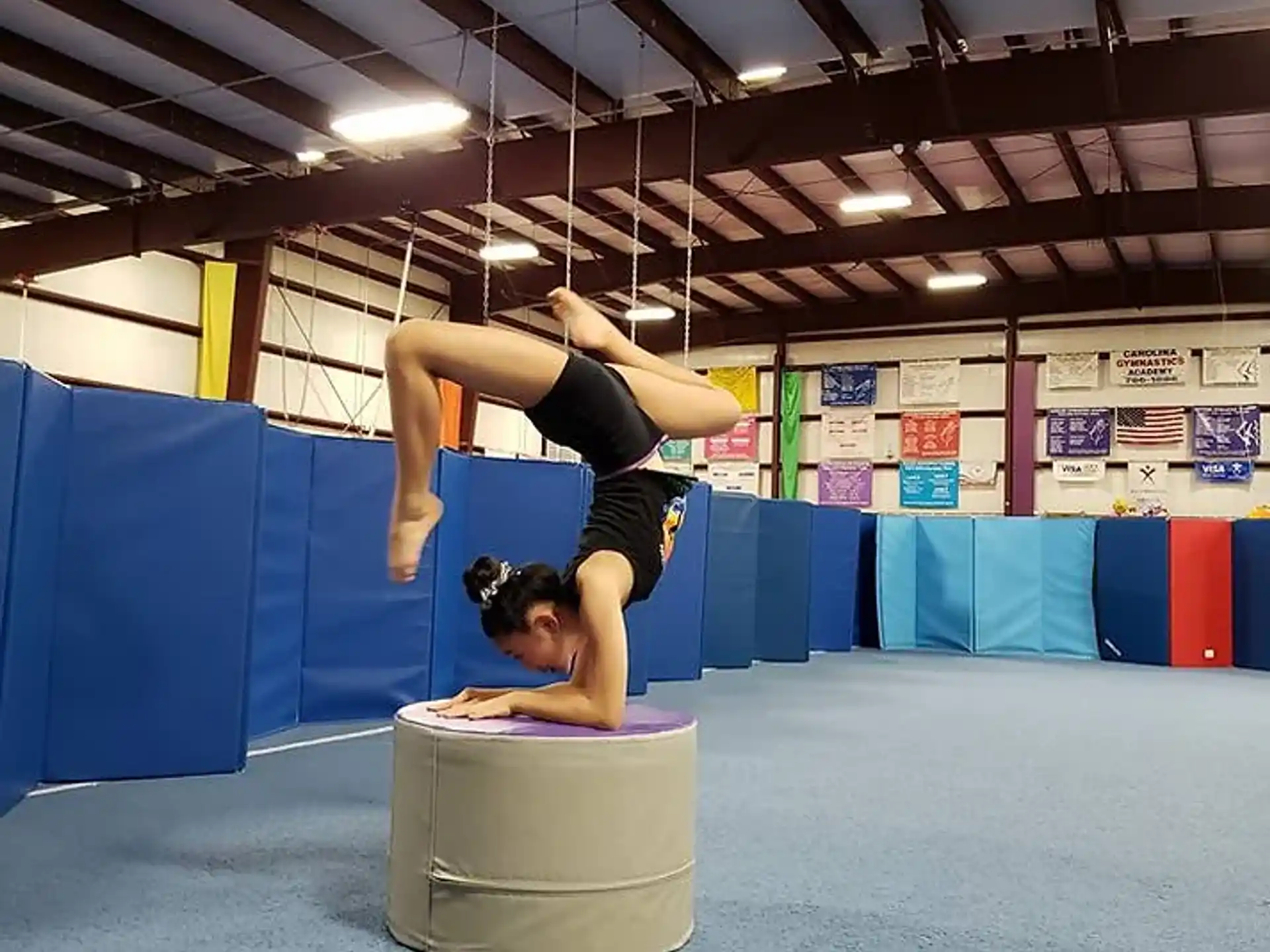 a person doing a handstand on a box in a room