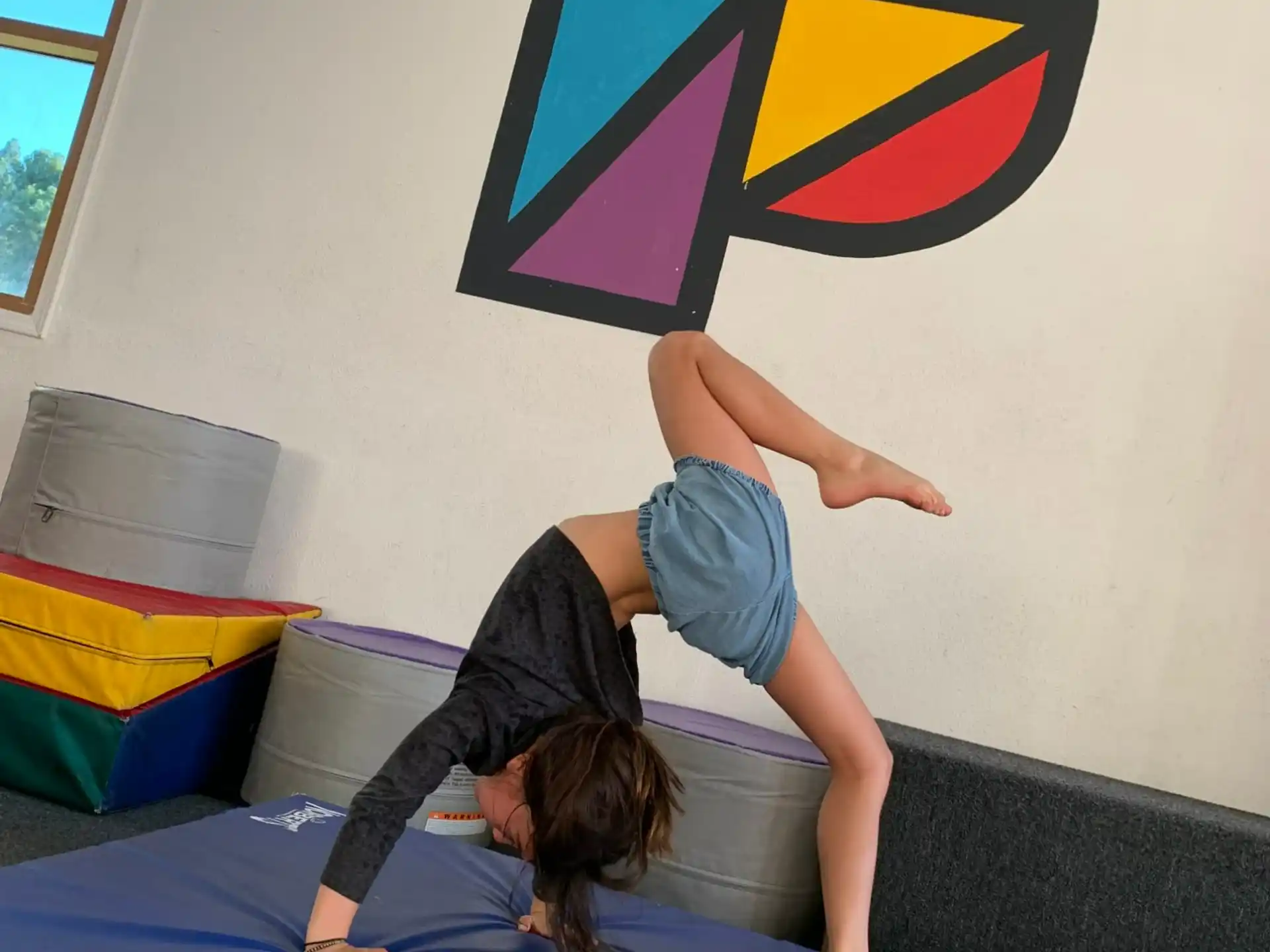 a person doing a handstand on a bed