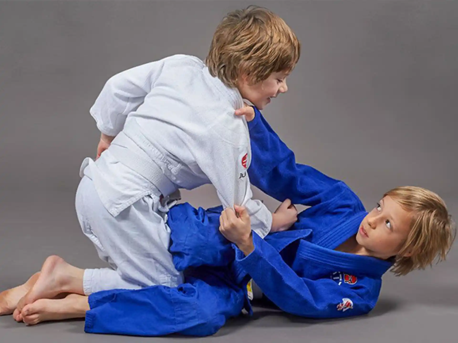 a boy and a girl in karate uniforms