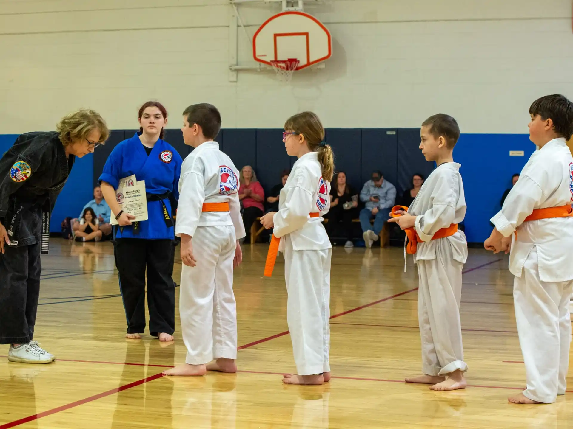 a group of people in karate uniforms
