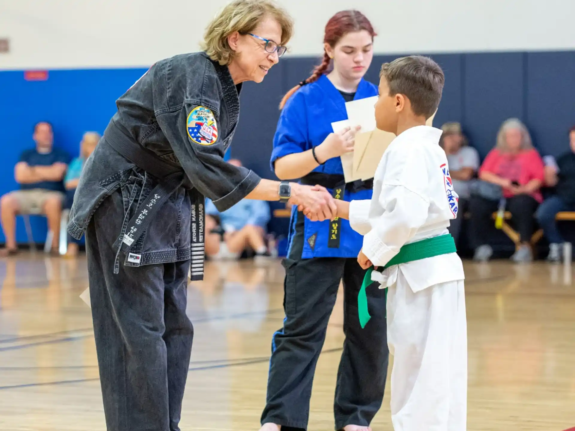 a person and a boy in a gym