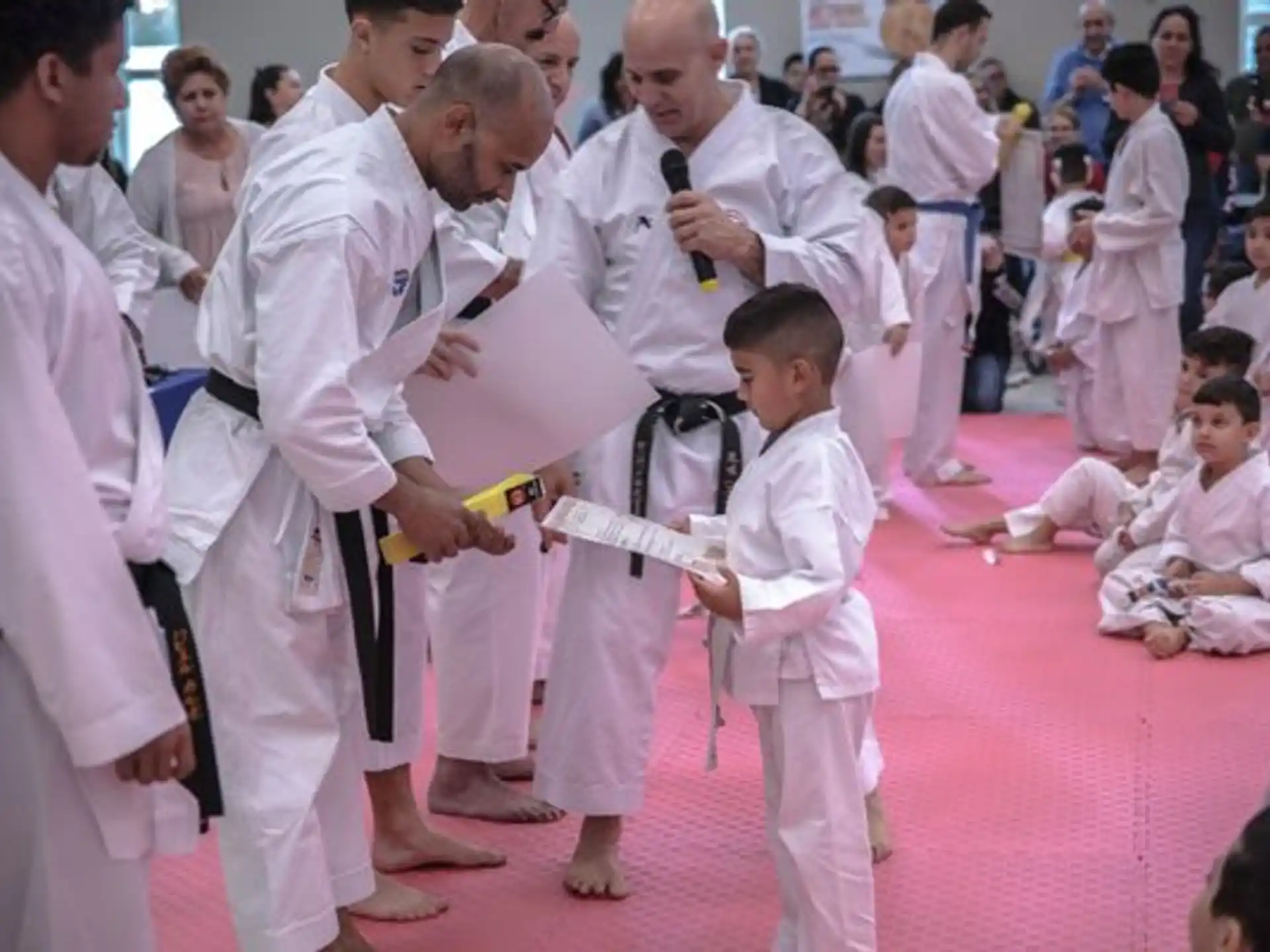 a group of people in white karate uniforms