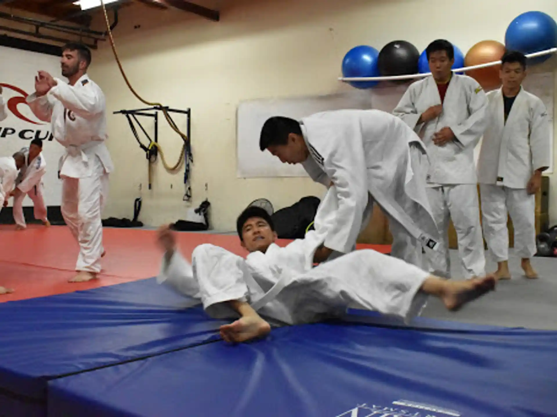 a group of people in white karate uniforms