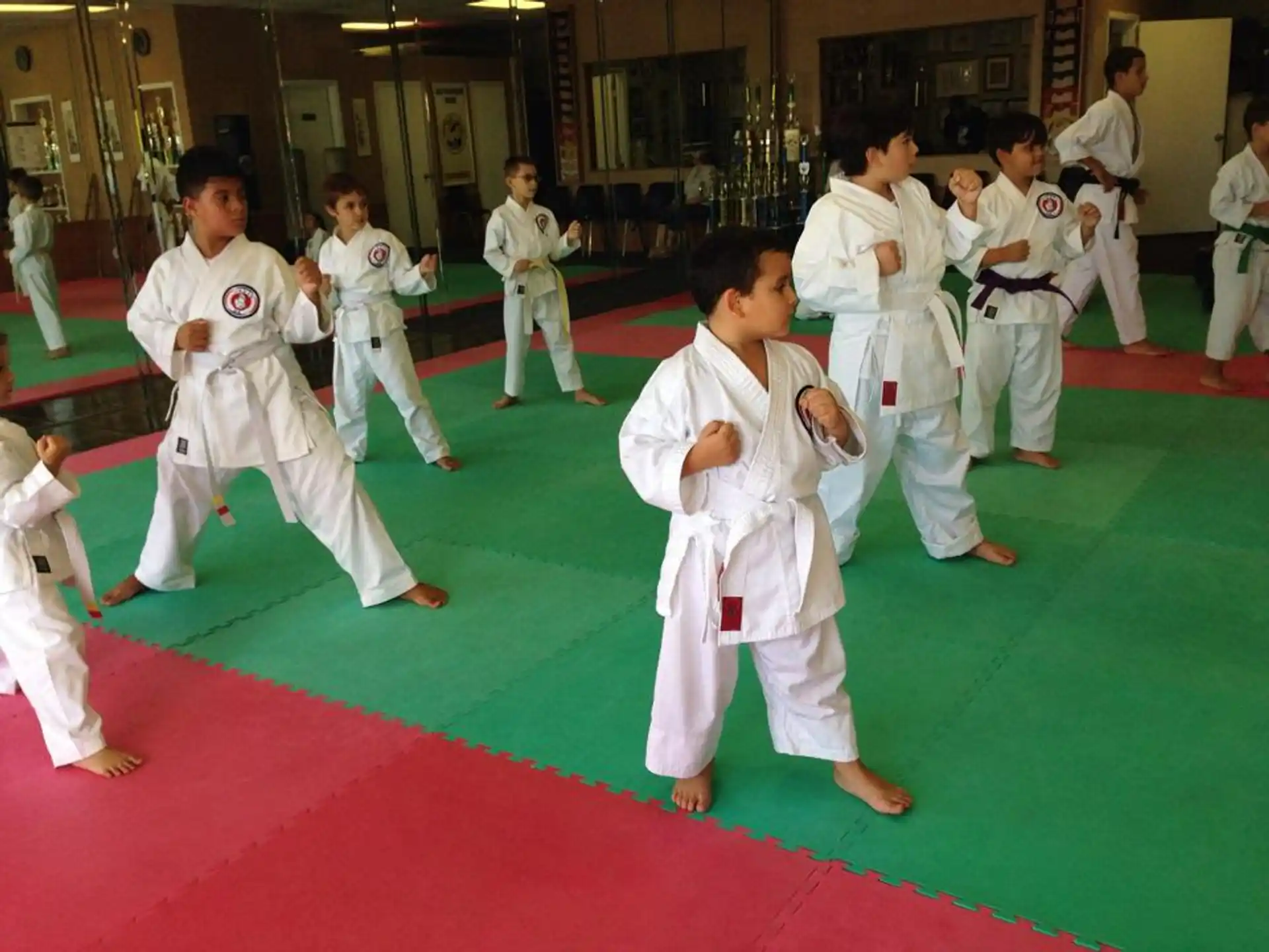 a group of people in white karate uniforms