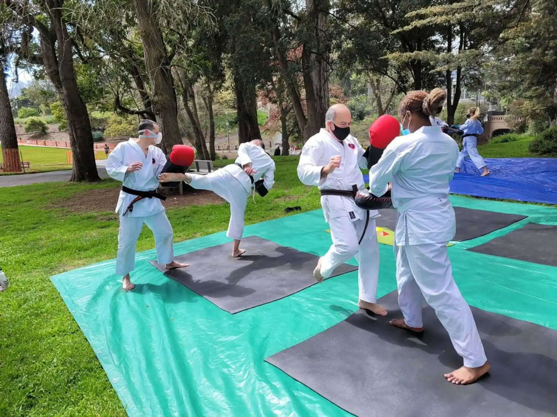 a group of people in white outfits practicing martial arts