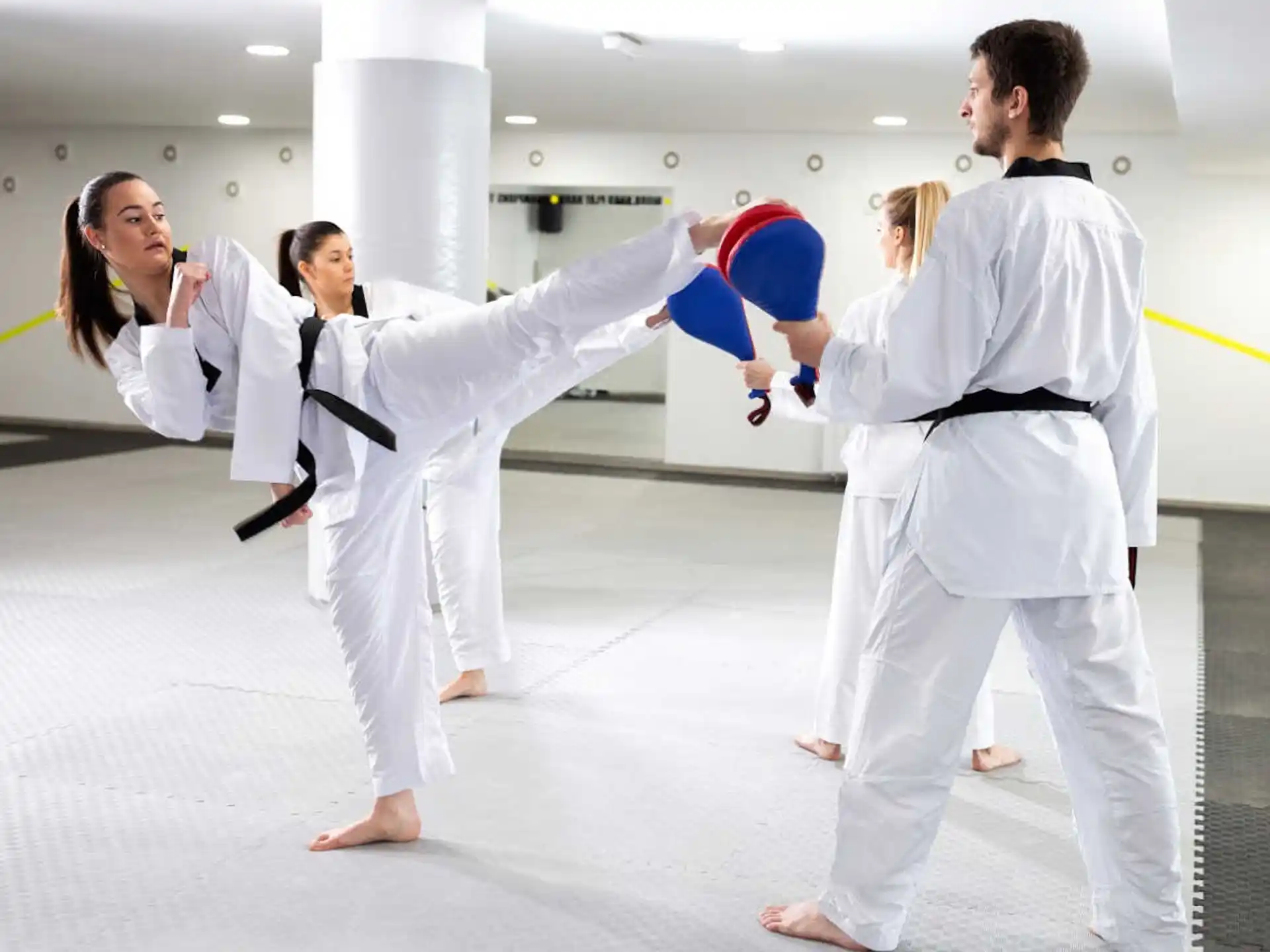 a group of people in white karate uniforms
