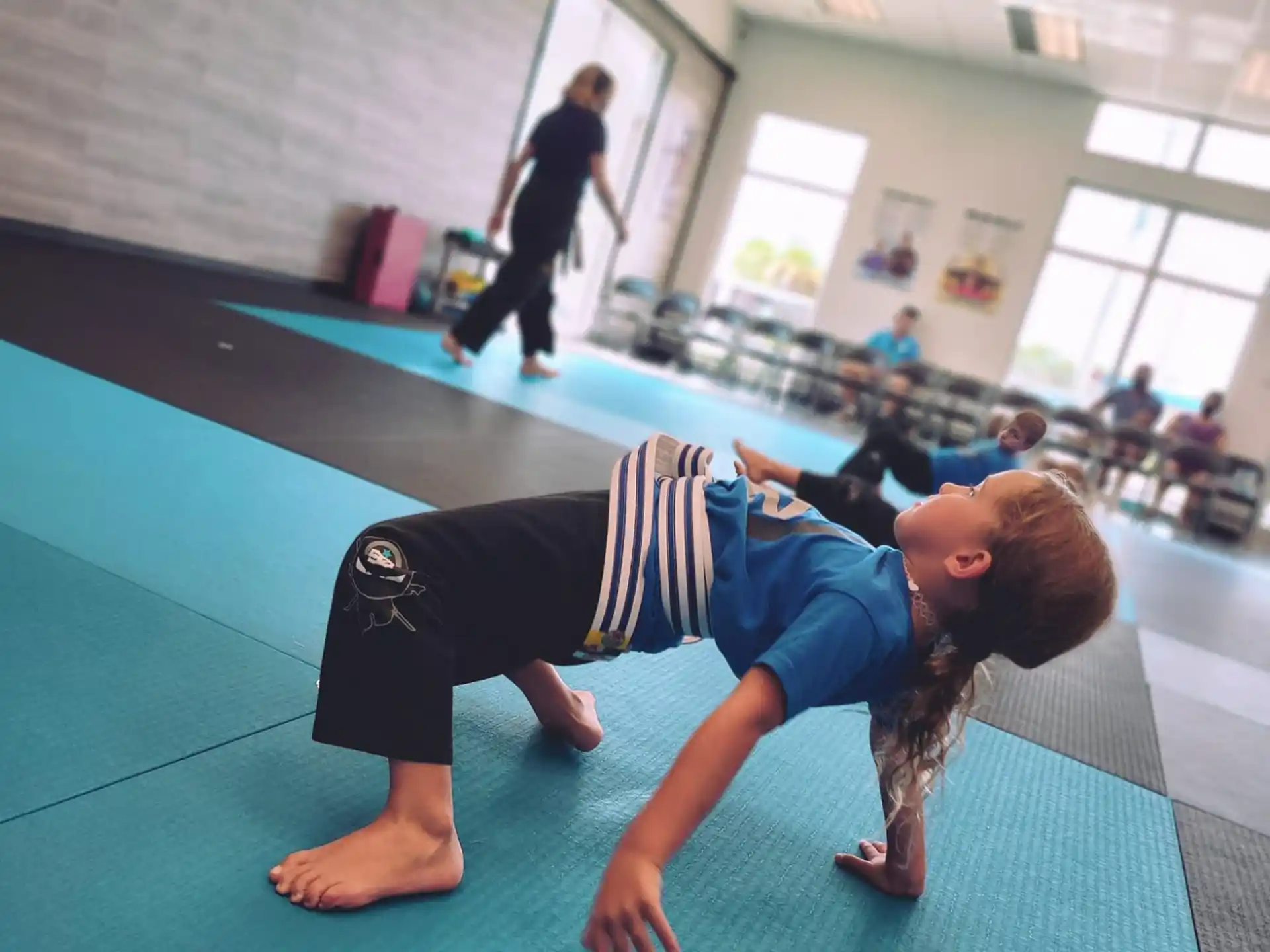 a man doing a push up on a mat in a gym