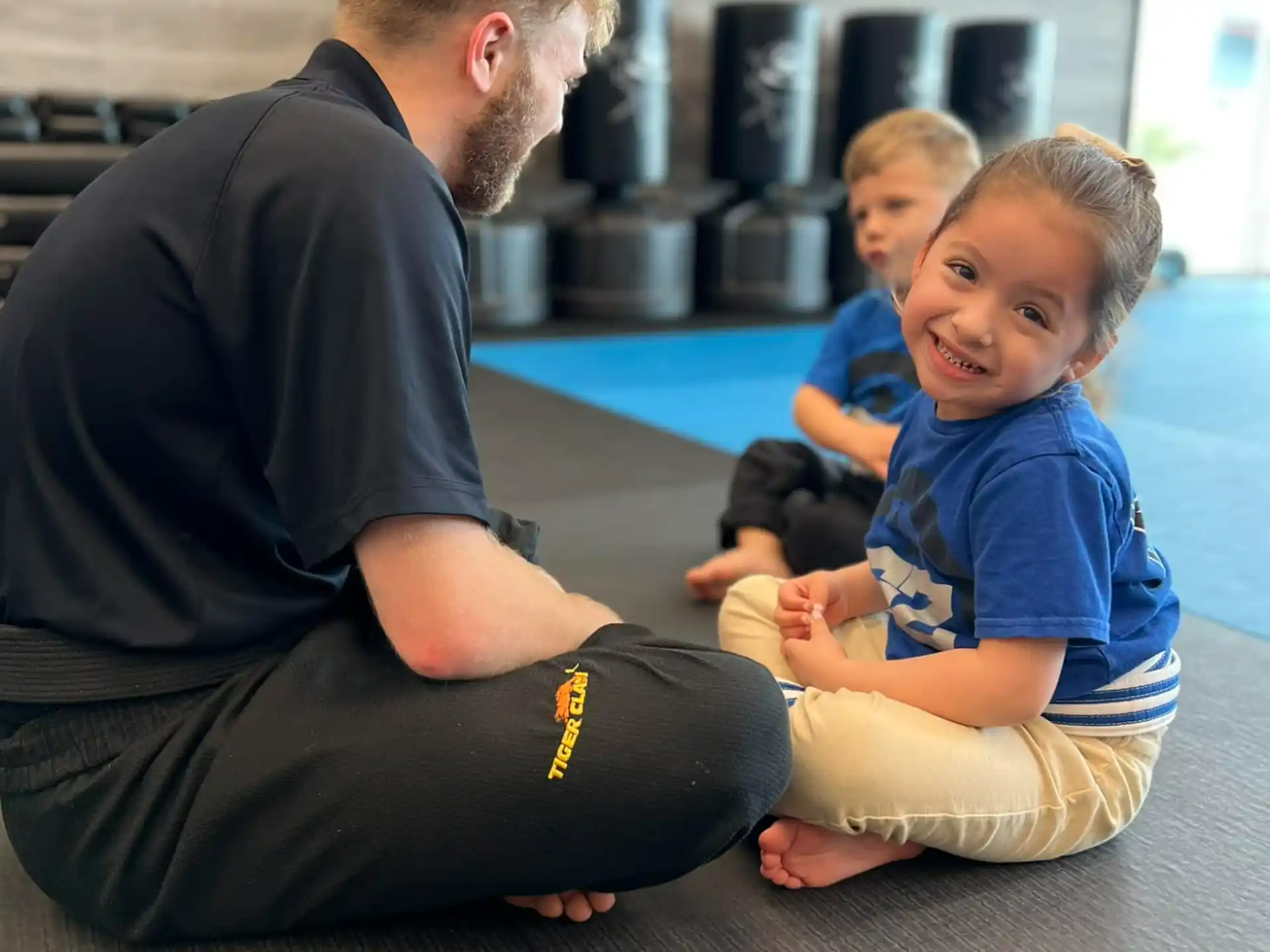 a person and two children sitting on the floor