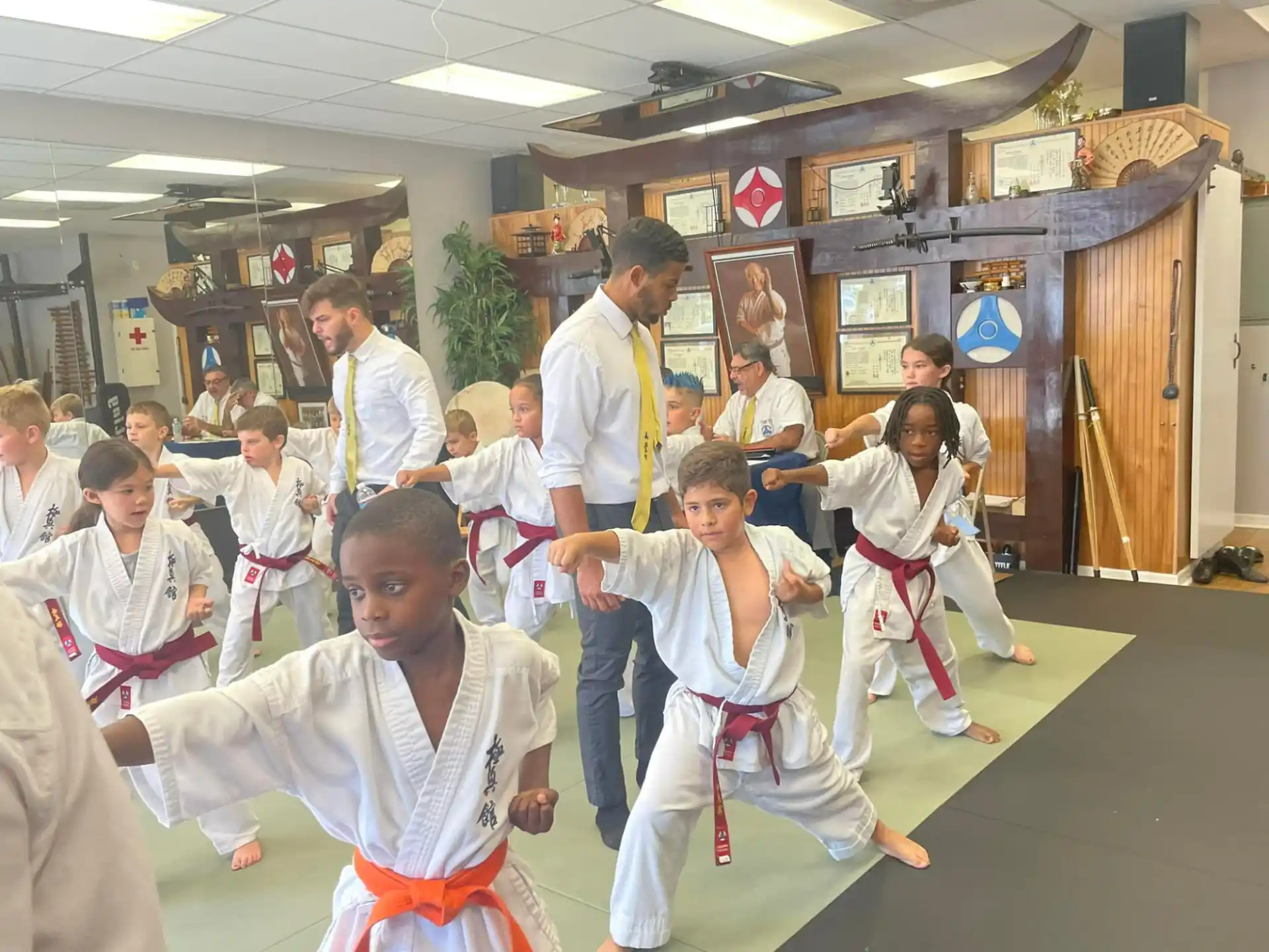 a group of children in karate uniforms
